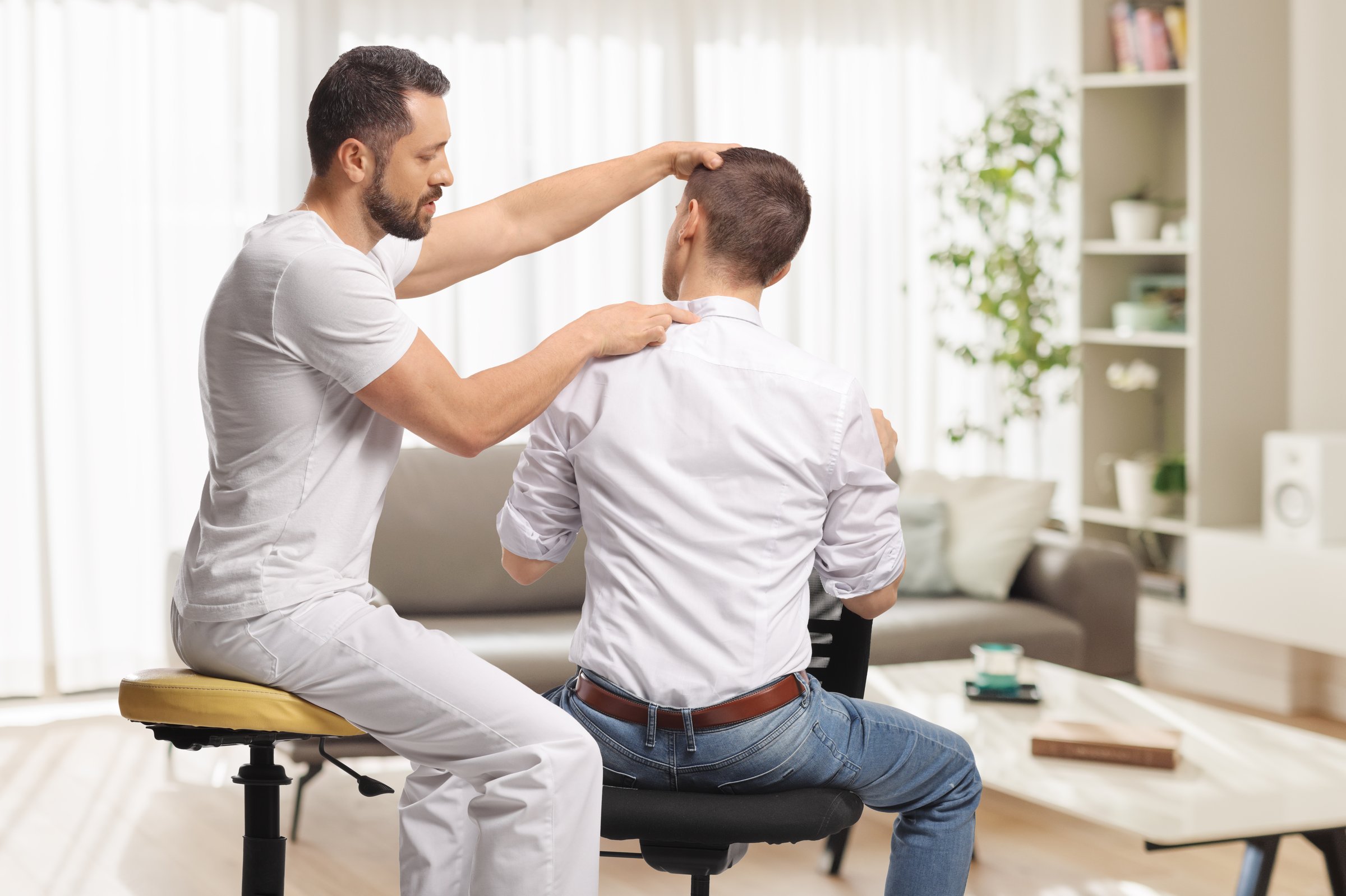 Chiropractor treating a young man for backpain