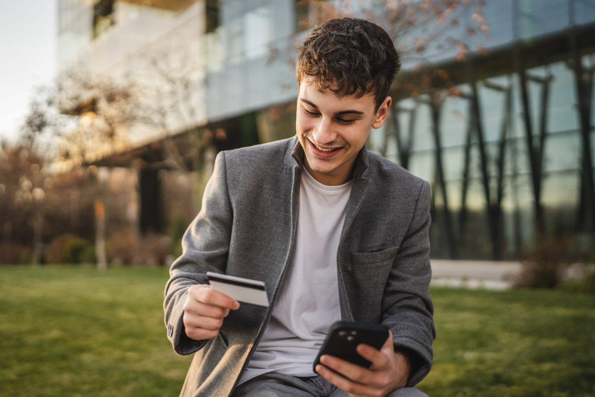adult man use mobile phone and credit card for online shopping outdoor