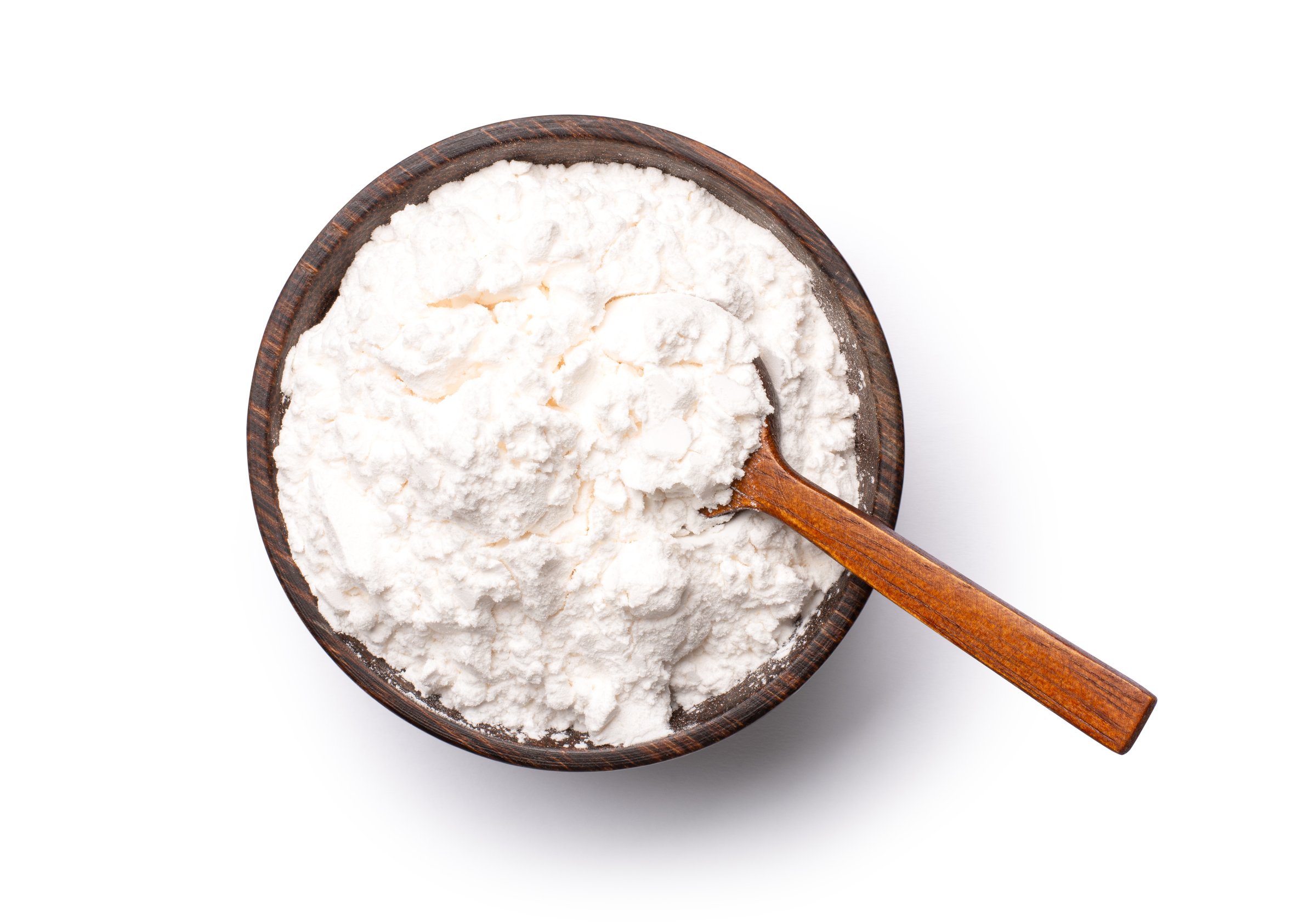 White flour or powder in wooden bowl isolated on white background. Overhead view, flat lay