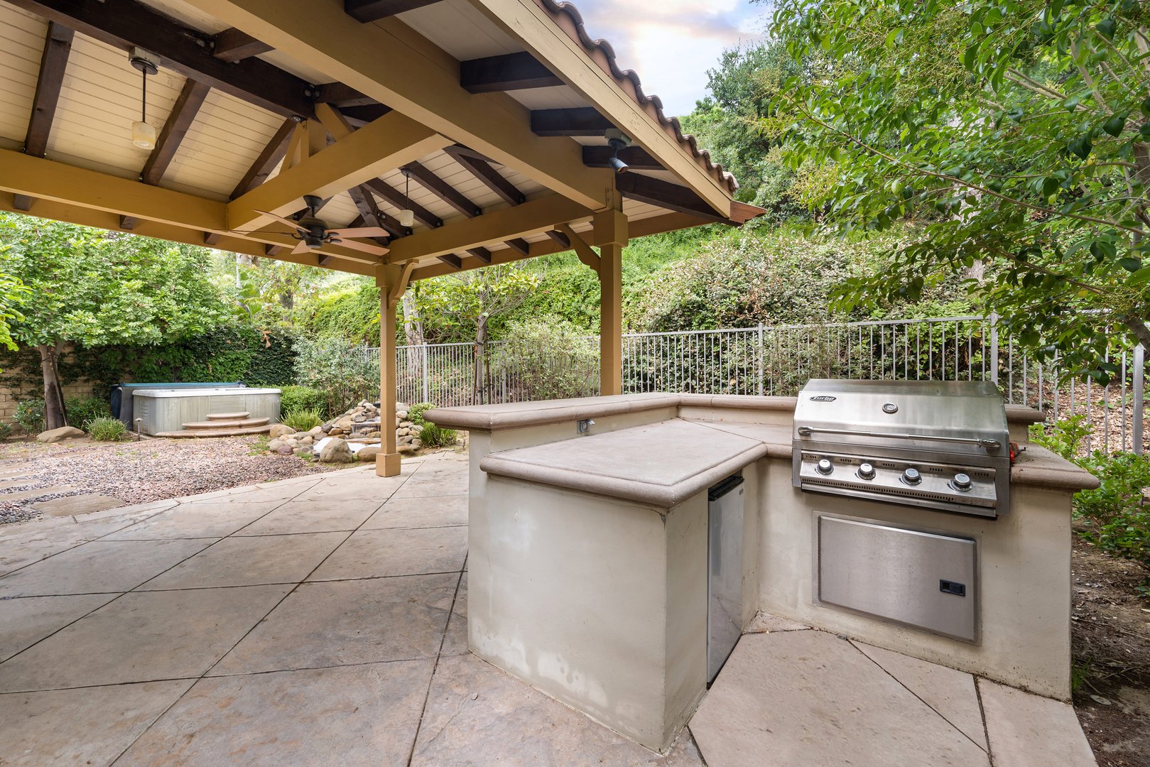 An outdoor grill and cooking space under a wooden patio cover. California, USA
