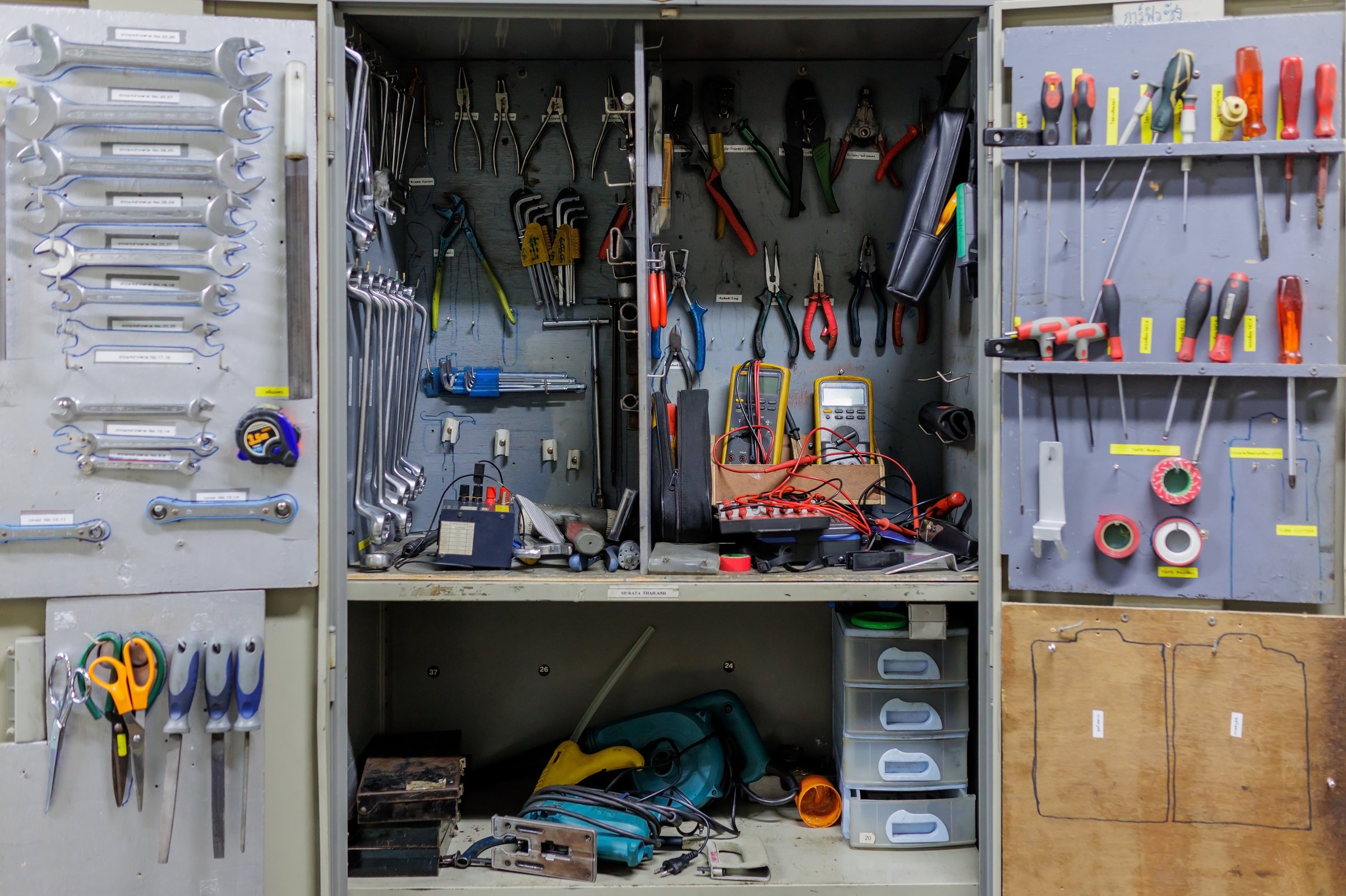 An open metal tool panel showcasing various hand tools like a hammer, screwdriver, and wrench. This clean and simple image, represents professionalism, organization, and readiness for work.
