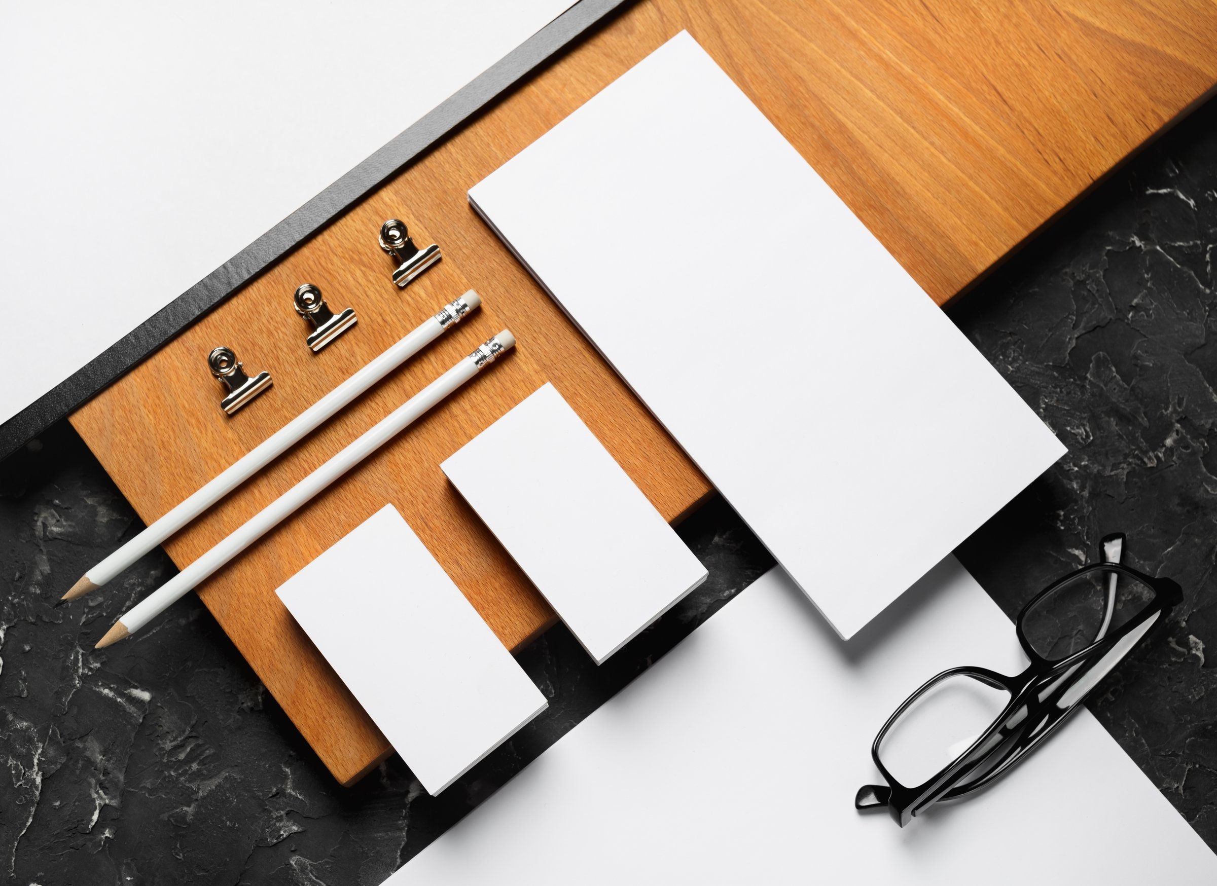 Blank corporate stationery template and wooden board. Mockup for design presentations and portfolios. Flat lay.