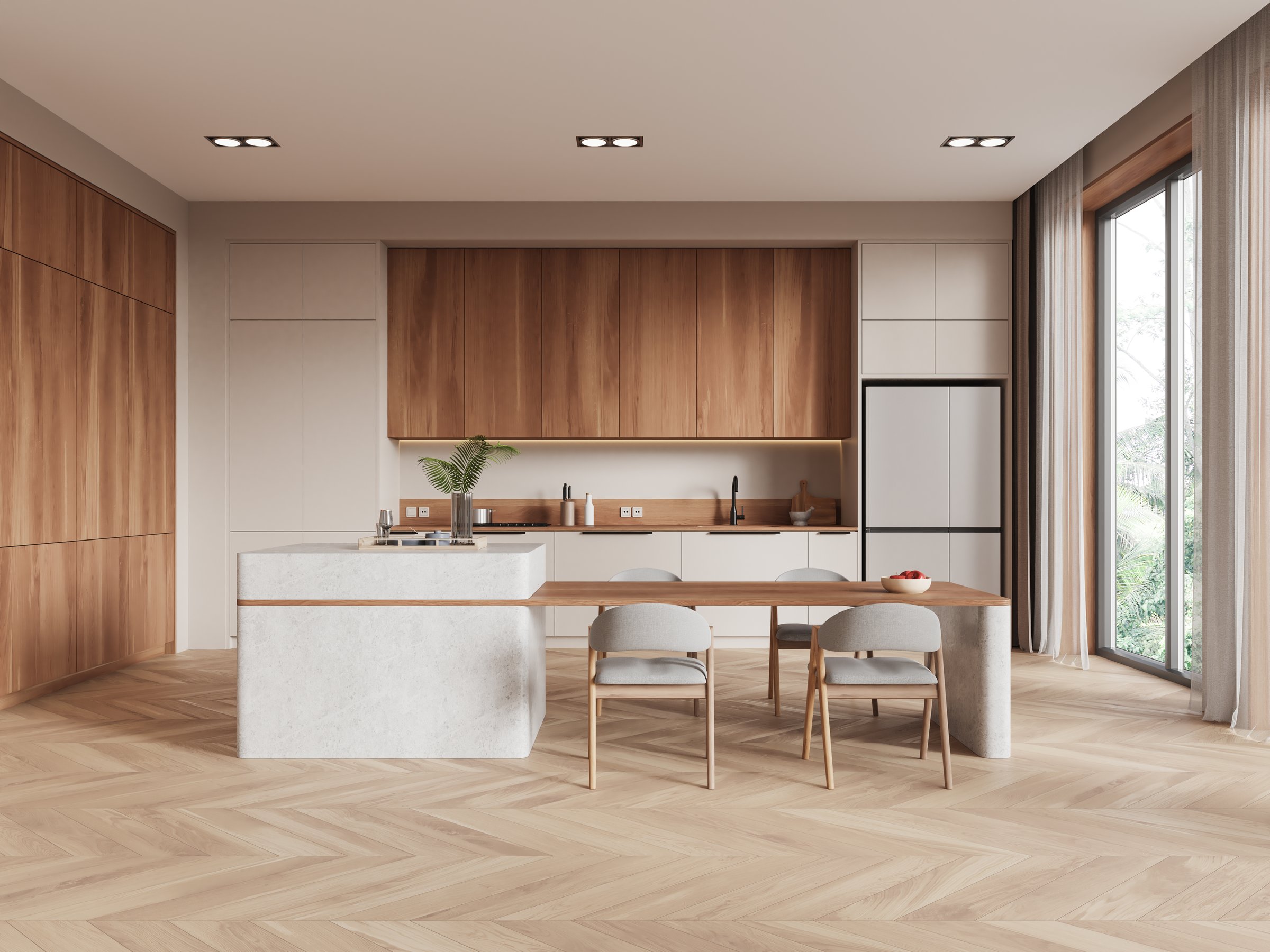 Contemporary kitchen interior with light wood cabinets, island and dining table