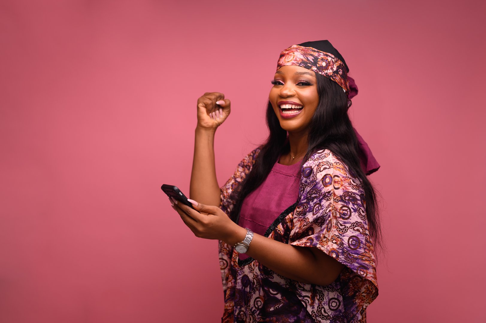 Black Africa Businesswoman using phone , mature woman received notification of online good news, worker celebrating victory rejoices, holding hand up gesture of triumph and achievement.