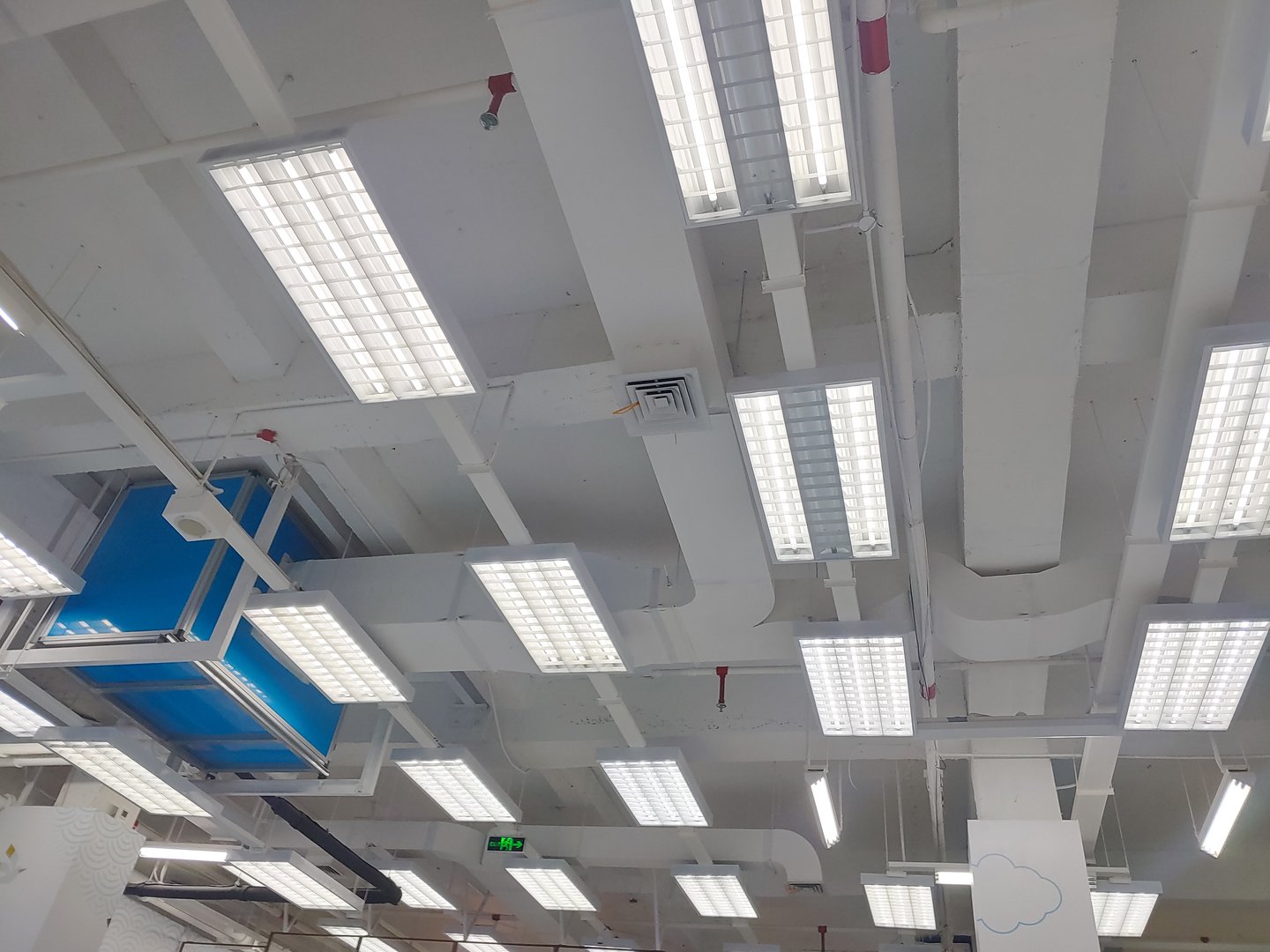 LED lights and Ventilation system in shopping mall, pipes hvac duct tube hanging from ceiling store inside for conditioner air.
