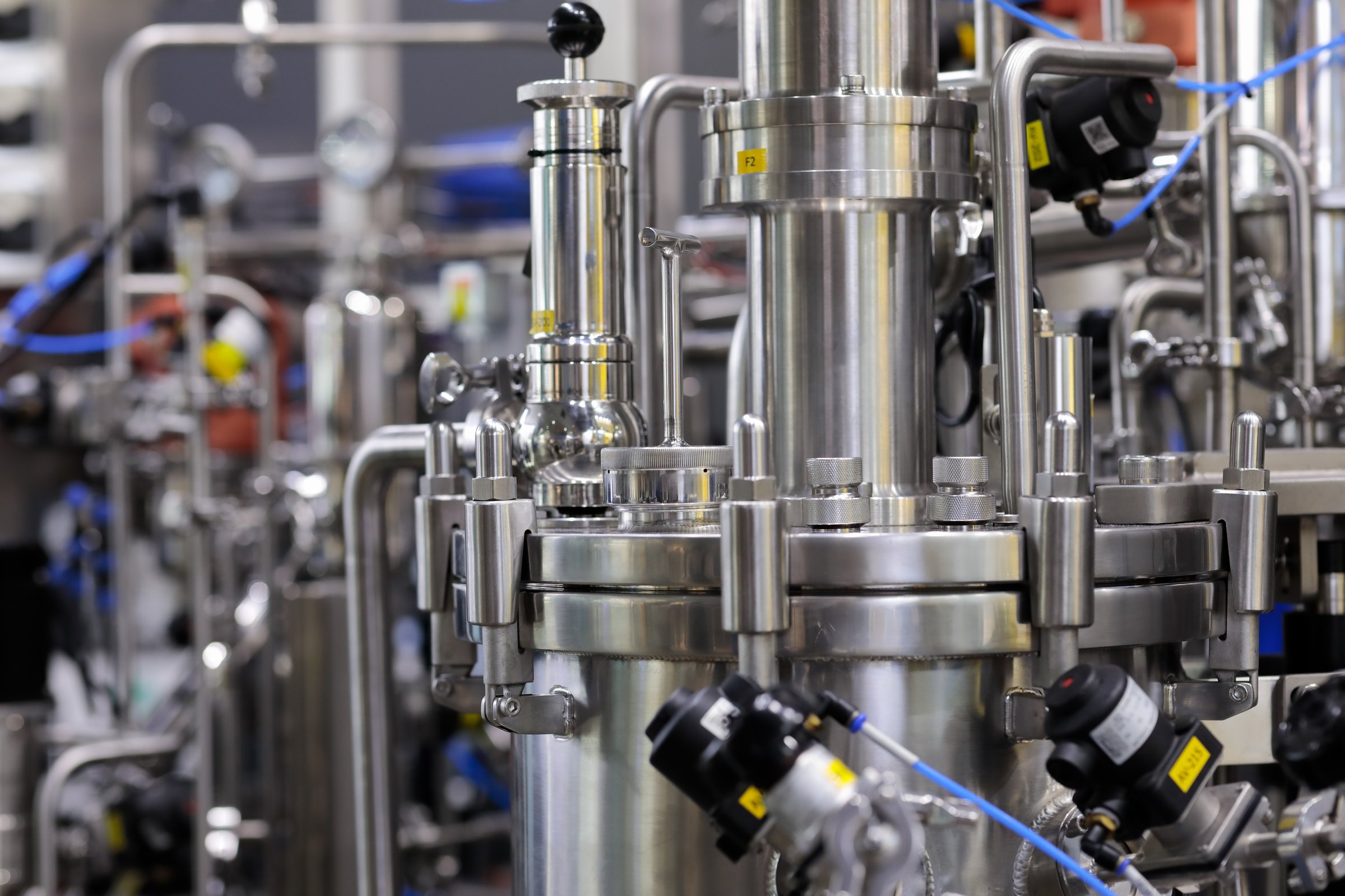 Industrial chemical process equipment in pharmaceutical plant. Medicine production equipment. Selective focus.