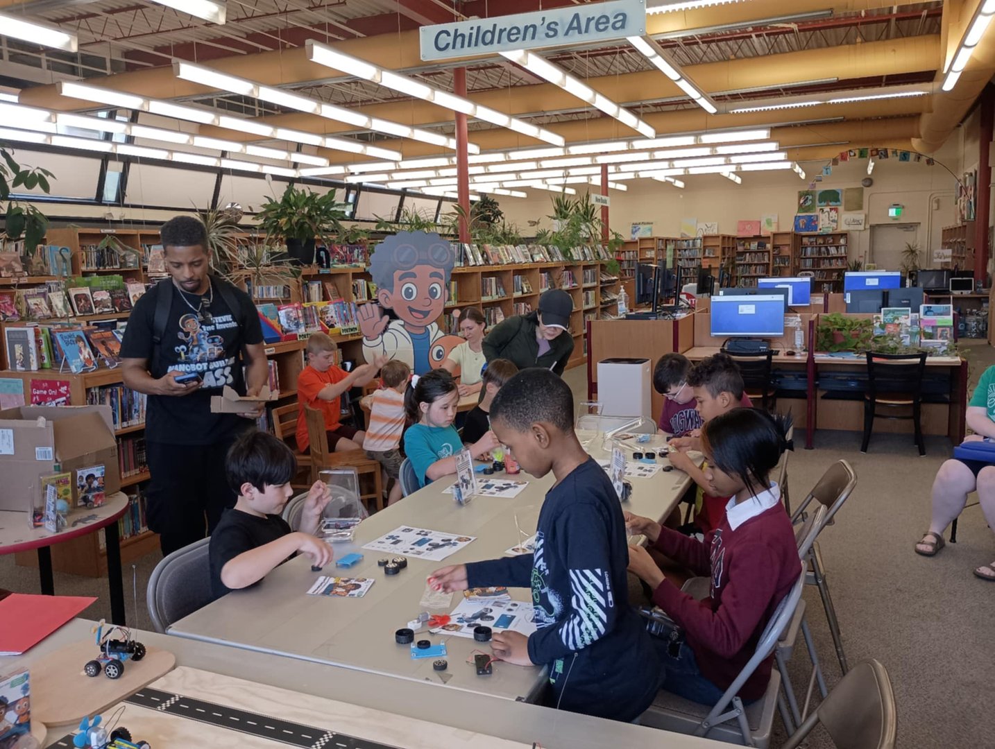 Stevie The Inventor's robot building class in action with happy kids