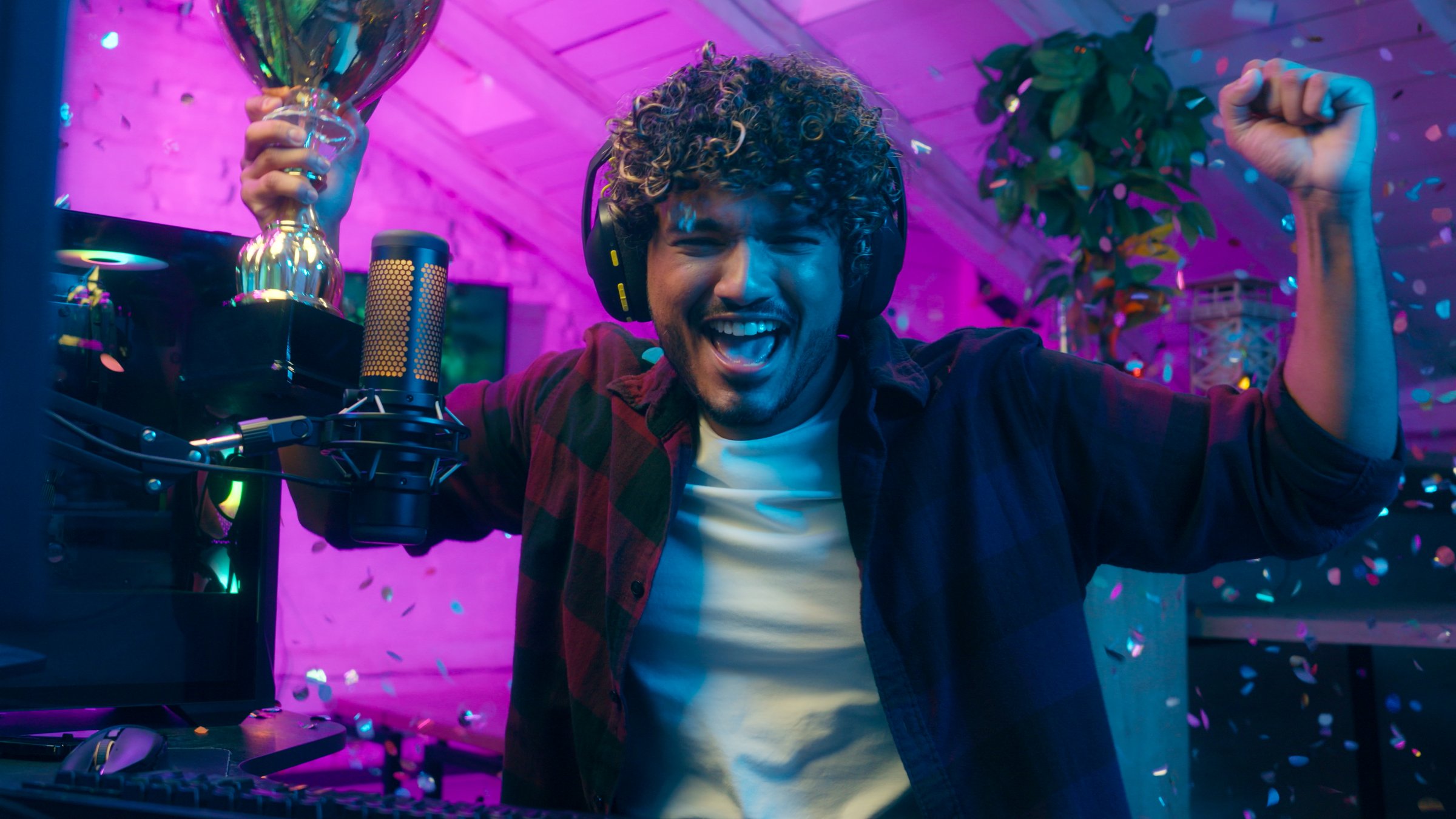 Latino Arabian Muslim man prize victory cup gold first place excited emotions gamer streamer player presenter champion broadcast winner influencer competition cyber sport radio celebrate male guy blog. High quality 4k footage