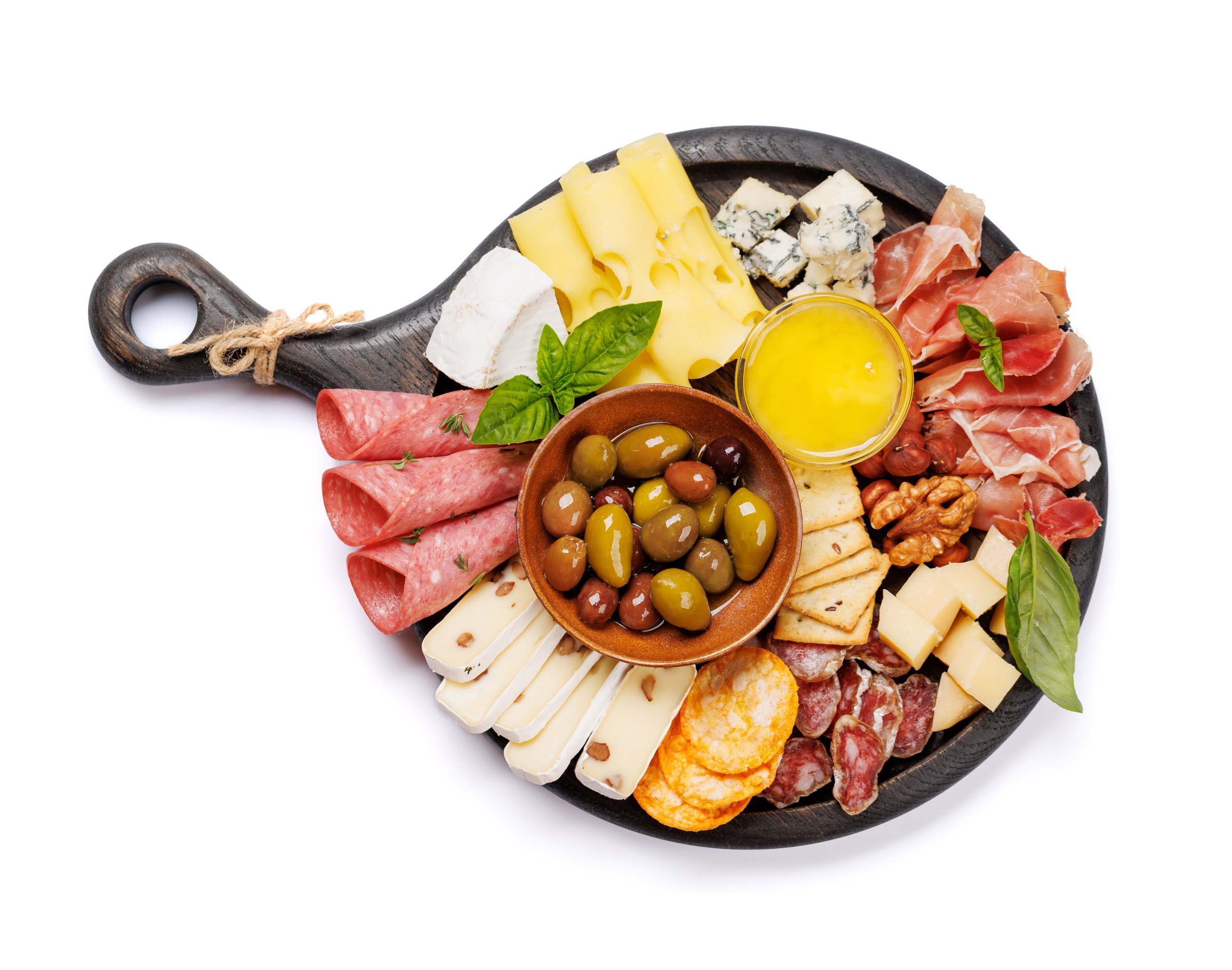 A selection of various cheeses and meats, perfect for an antipasto spread, showcasing a variety of flavors and textures. Isolated on white background