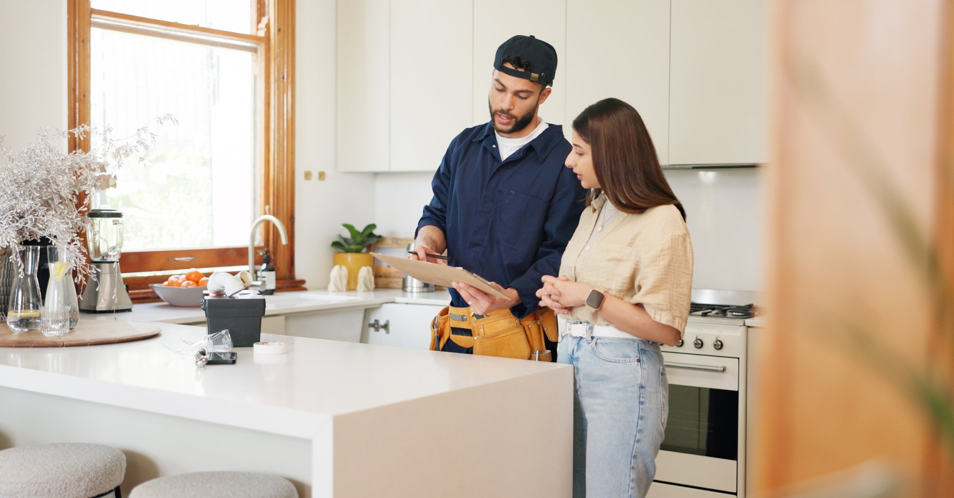 Woman, kitchen and plumber with contract on clipboard for maintenance service, information and repairs. House, discussion and man with notes in checklist for renovation, inspection or client feedback