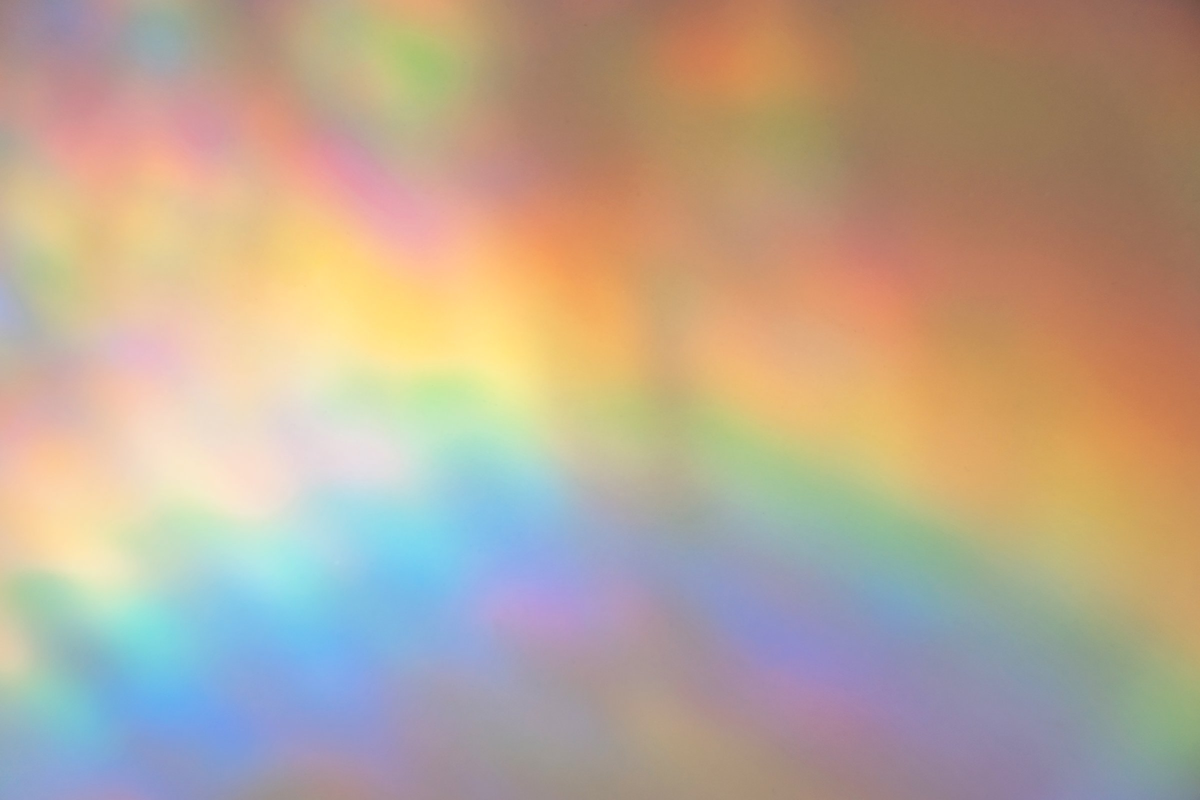 Background of blurred rainbow hologram close up.