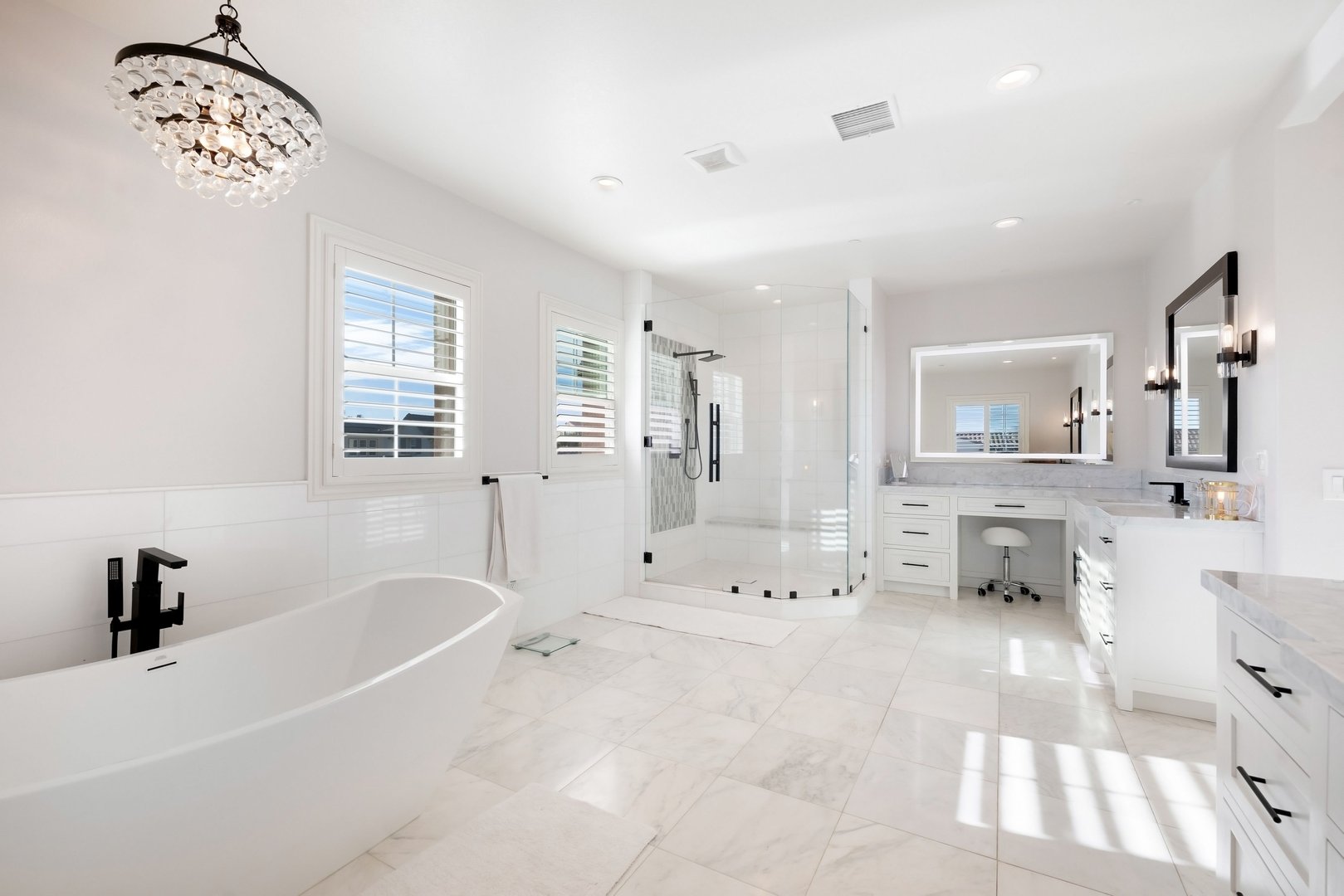 A bright and elegant bathroom with large windows in a luxury home