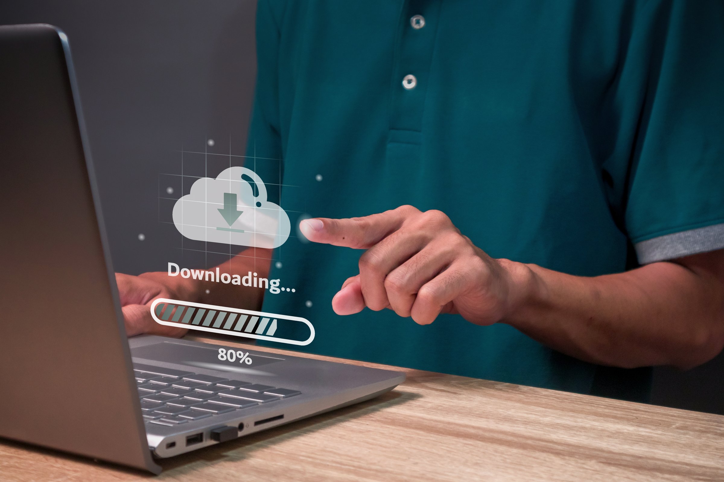 Man using a laptop to download data from cloud storage. Cloud technology and data storage concept.