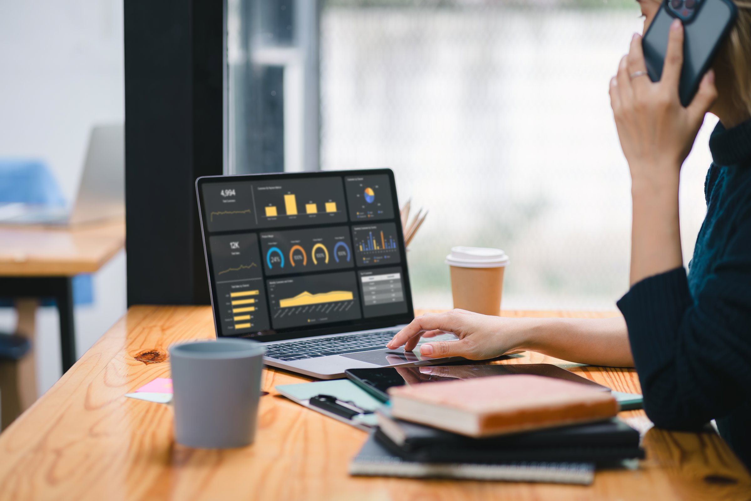 The data analyst woman working on a business analytics dashboard, utilizing charts and metrics to analyze performance and generate insightful reports for operations management