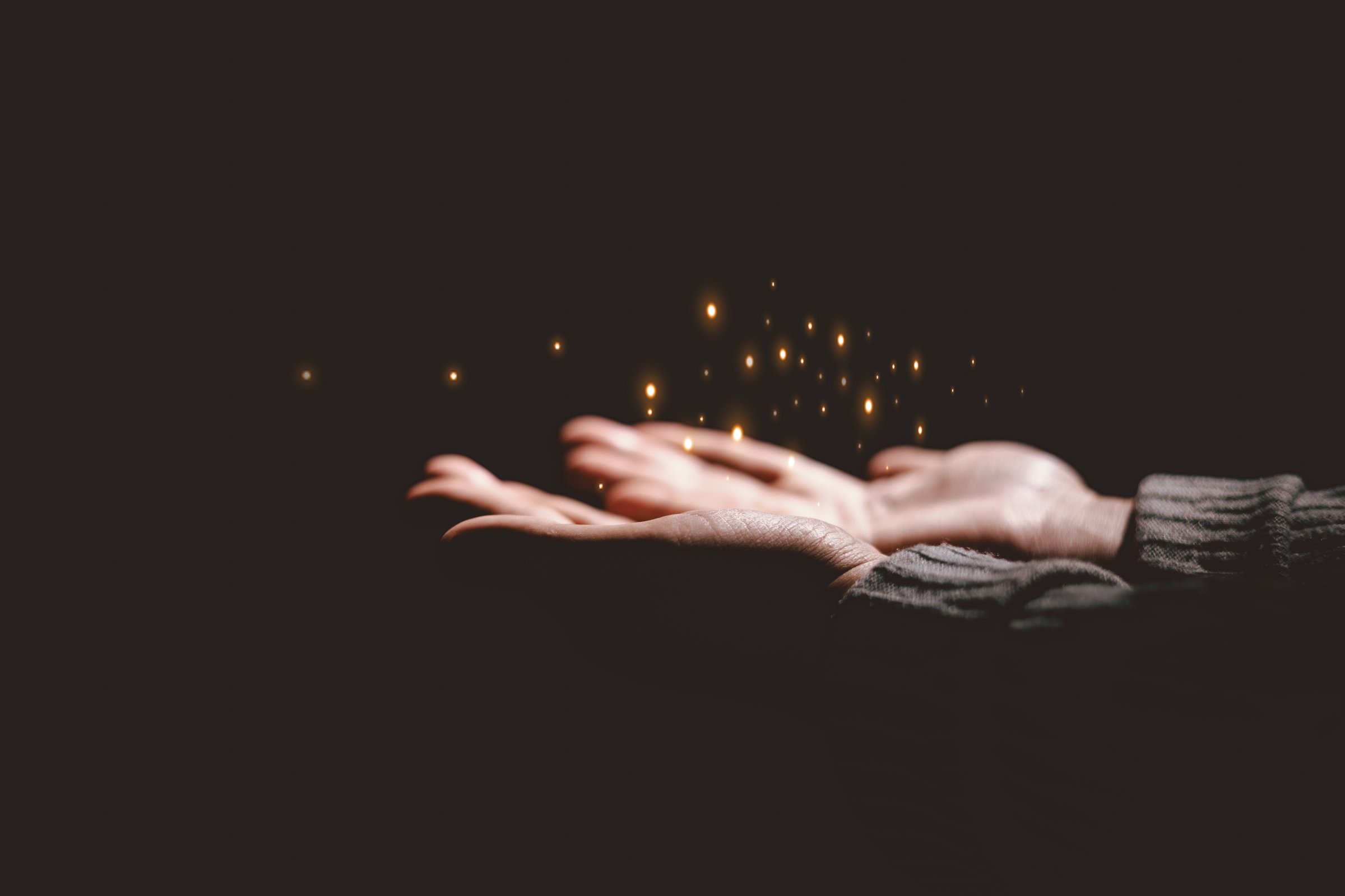 Hands holding glowing light, symbolizing hope, healing, faith, inspiration, spiritual energy, new beginning, miracle, inner strength and positive transformation from darkness to light.