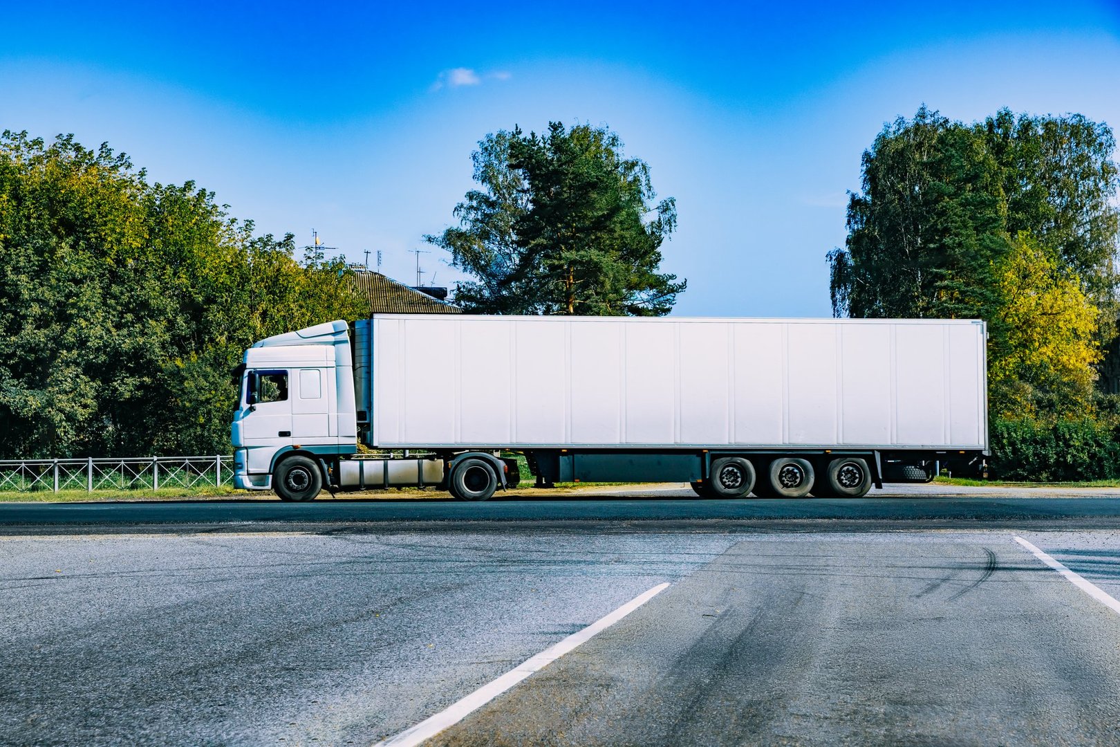 Big truck with semi-trailer Mockup. Truck transportation driving asphalt road, white long delivery truck. White empty mock-up truck