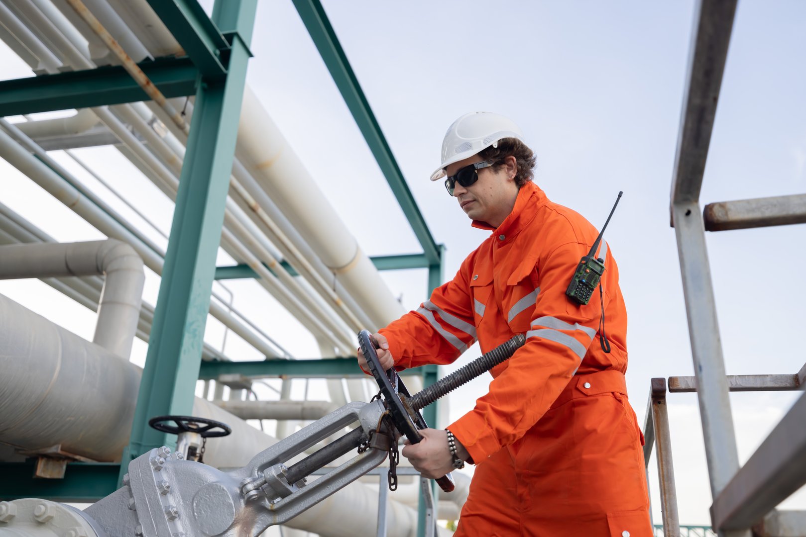 Engineer turning the hand wheel valve at the oil refinery site