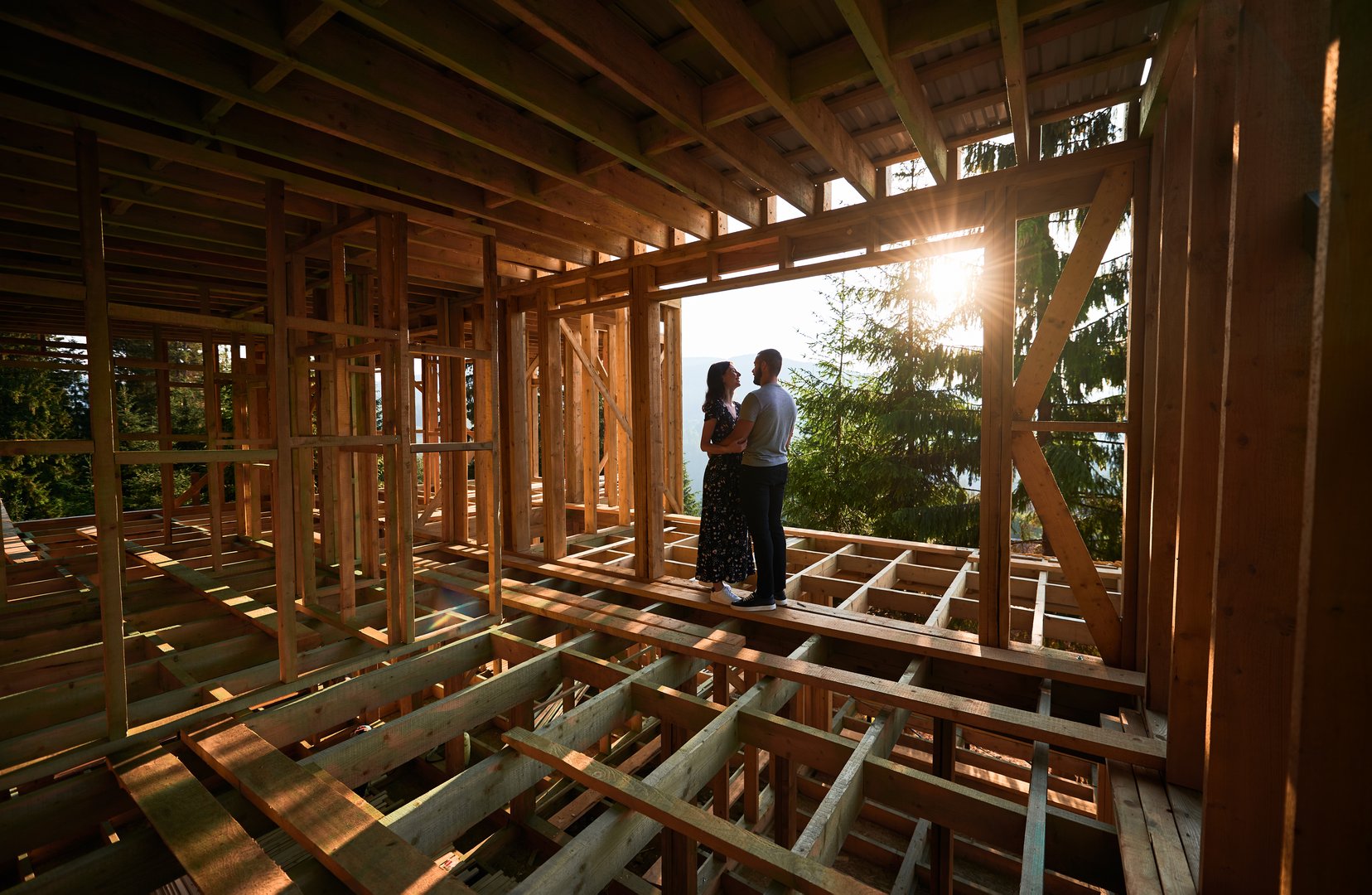 Man and woman inspecting their future wooden frame
