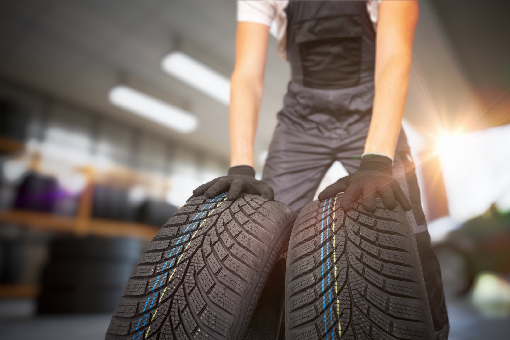 Car mechanic is changing tires. Concept of car repair.