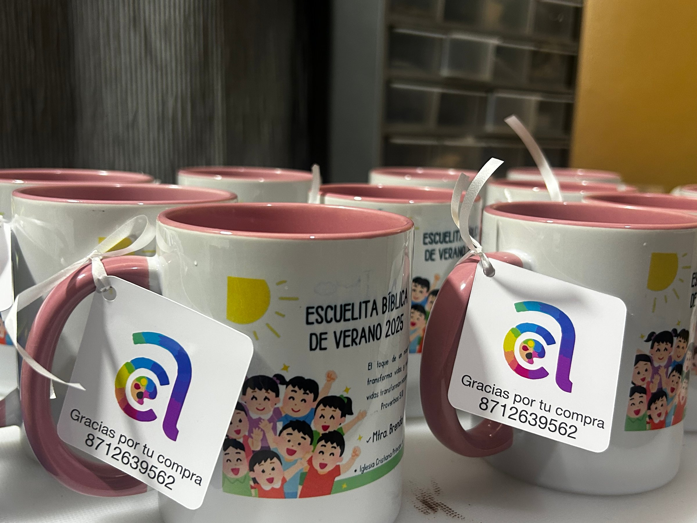 Hands of a young woman holding a custom made Calendar printed using travel photos. Sitting comfortably on a white sofa at home.