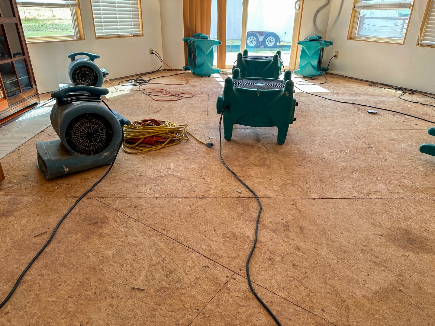A group of air movers drying out a home after a water loss