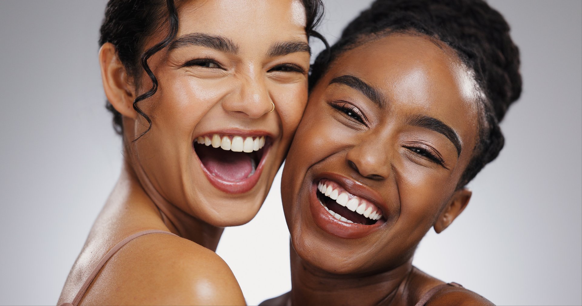 Portrait, shine or women with skincare, funny or dermatology on white studio background. Face, friends or people with glow, aesthetic or grooming routine with treatment, luxury or wellness with humor