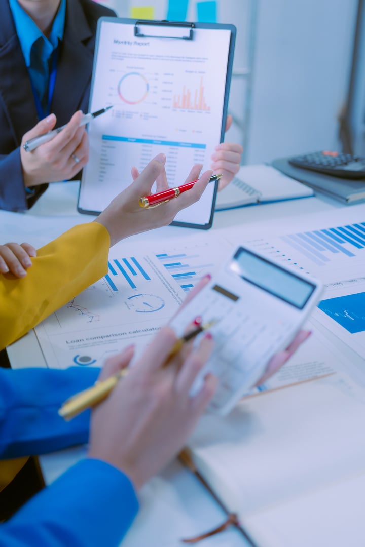 Business team analyzing income charts and graphs with laptop computers, business analysis and strategic thinking Startup business group meeting  Close-up photo