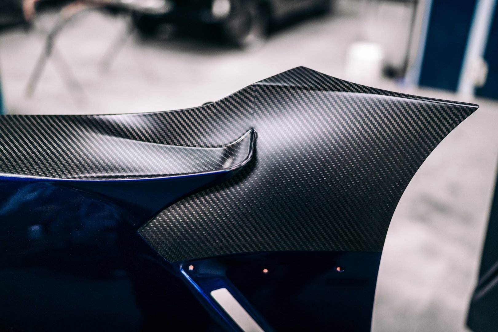 Blue car with a carbon fiber fender