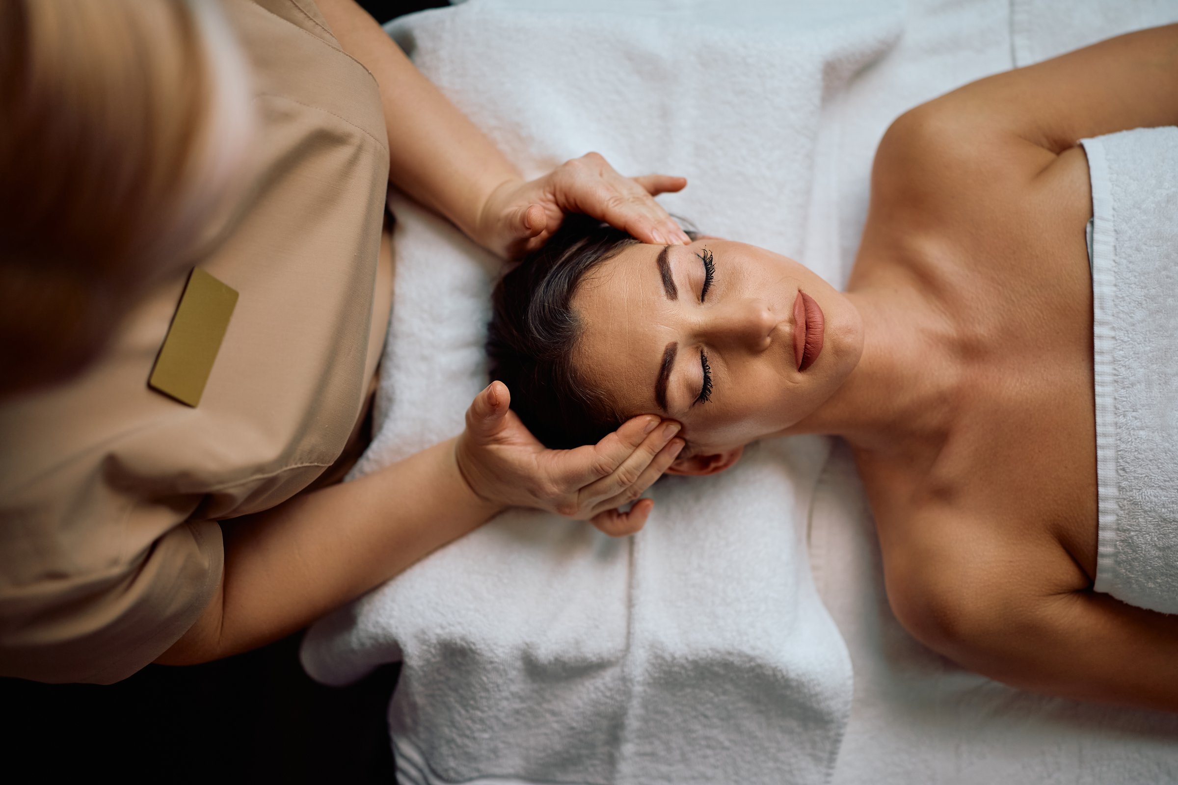 High angle view of woman enjoying in head massage at the spa.