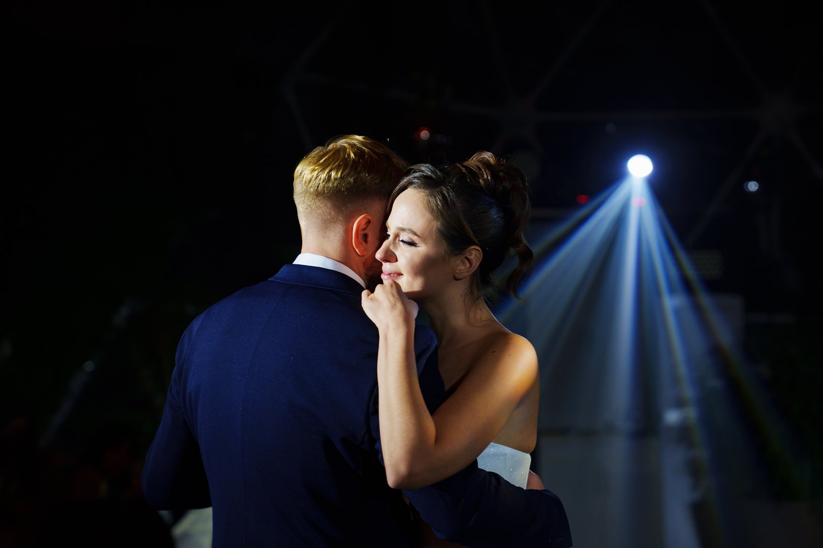 The bride and groom dance the first dance at the wedding banquet. Romantic tradition.
