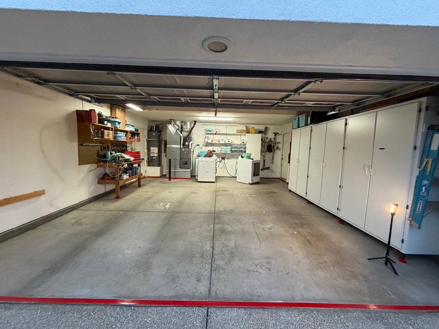 Raw concrete floor during preparation with red tape markings