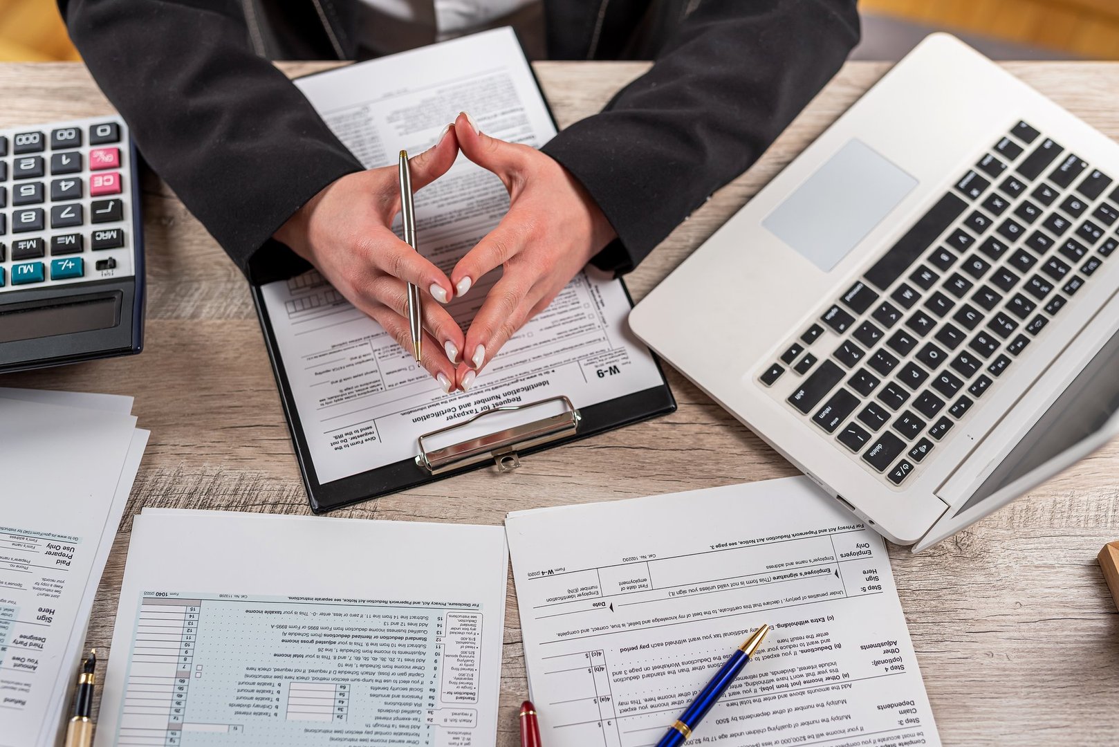 young woman work with tax form 2022. Deduction planning concept. April time for tax, deadline