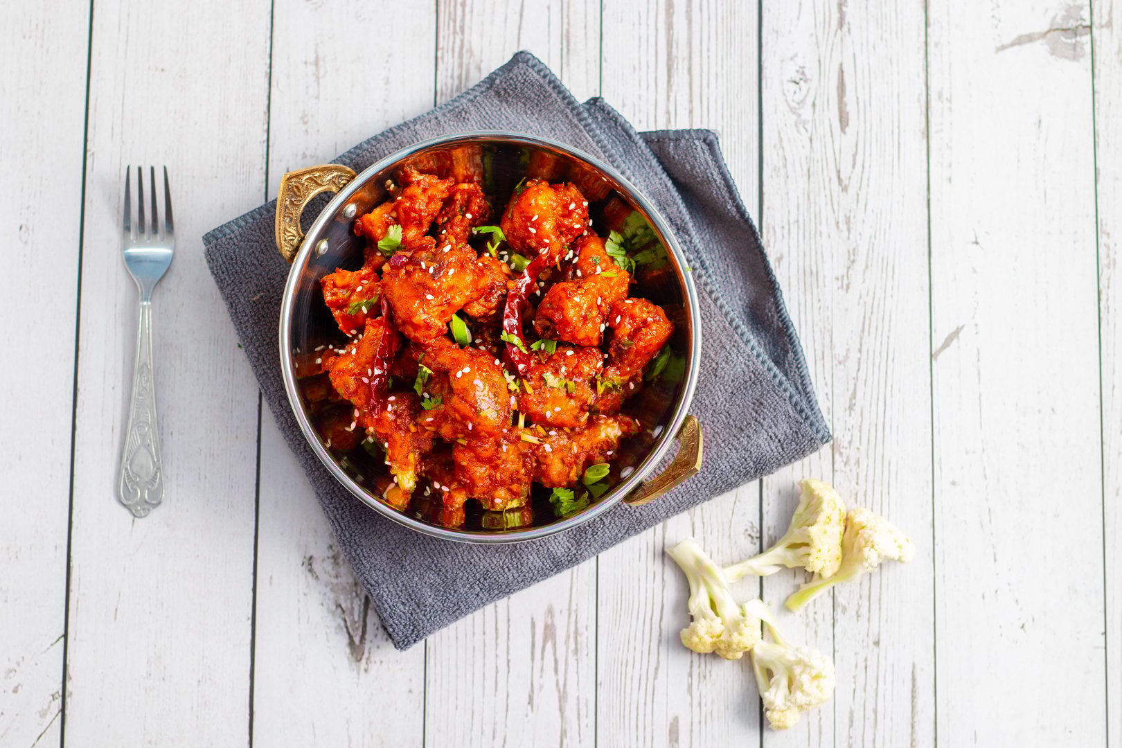 Gobi Manchurian is a crispy, spicy Indo-Chinese dish made with battered, fried cauliflower tossed in a tangy, flavorful soy-garlic sauce