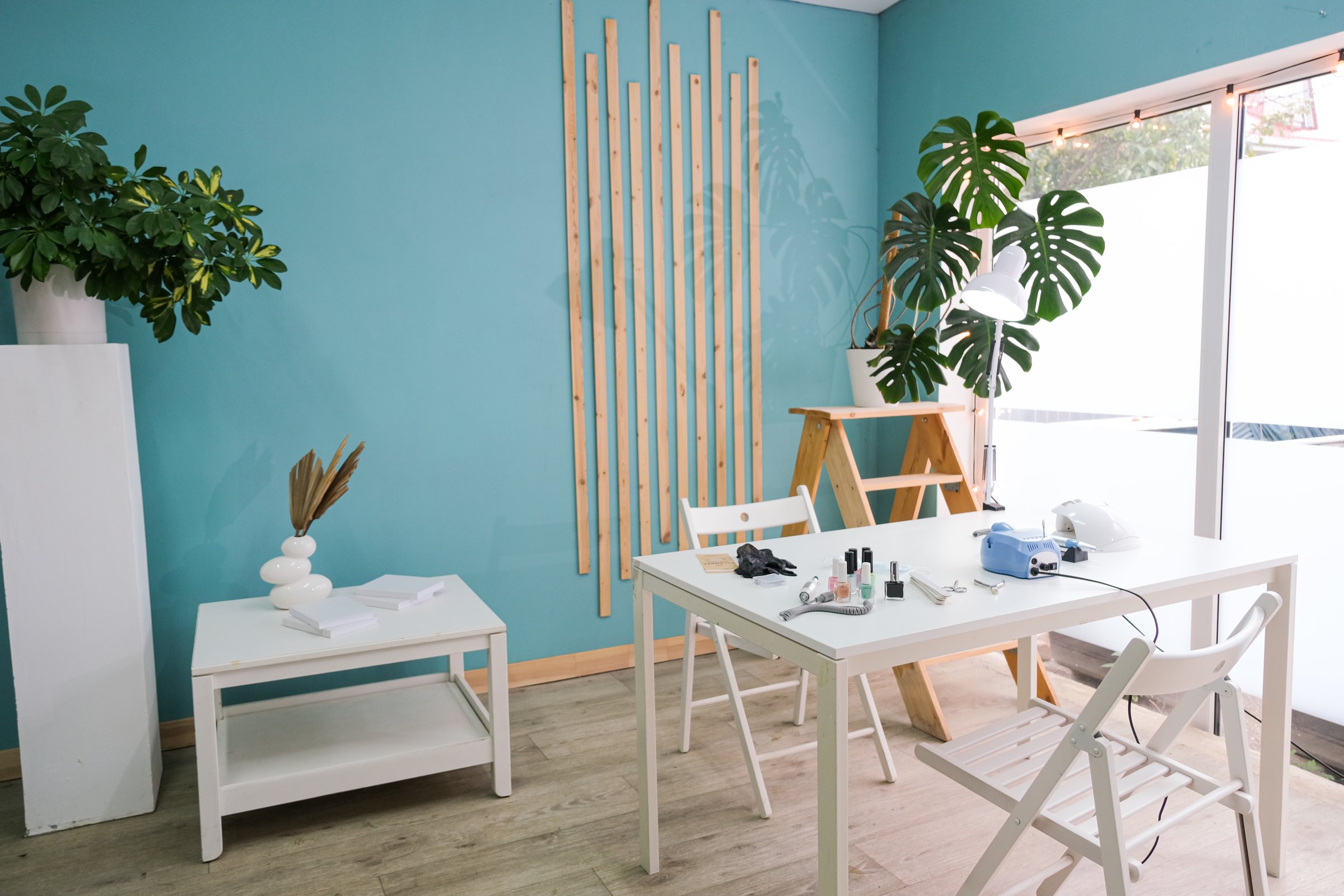 beauty nail salon at home space, blue walls, large windows. working from home