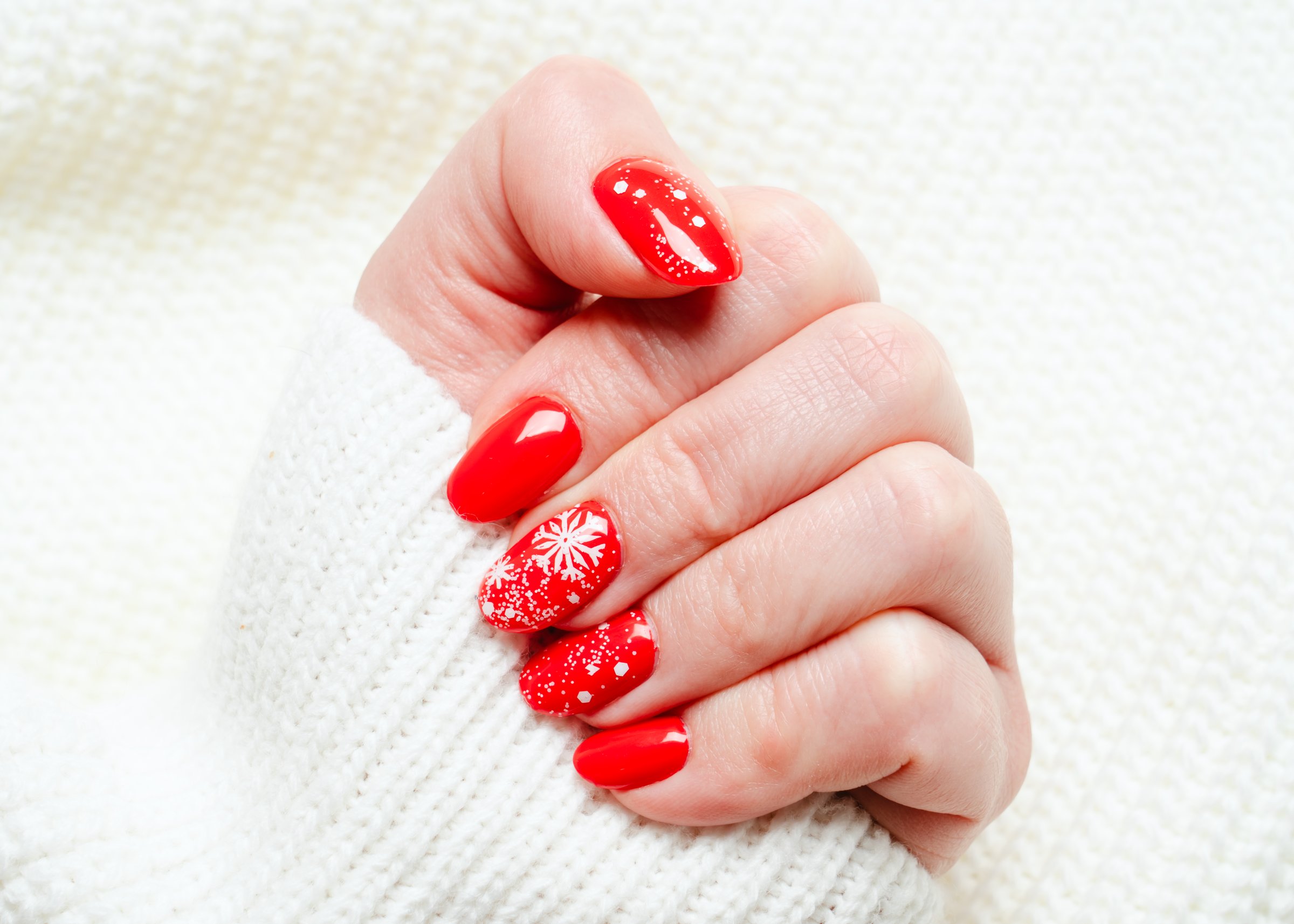 Christmas manicure, Beatiful red nails on white background.