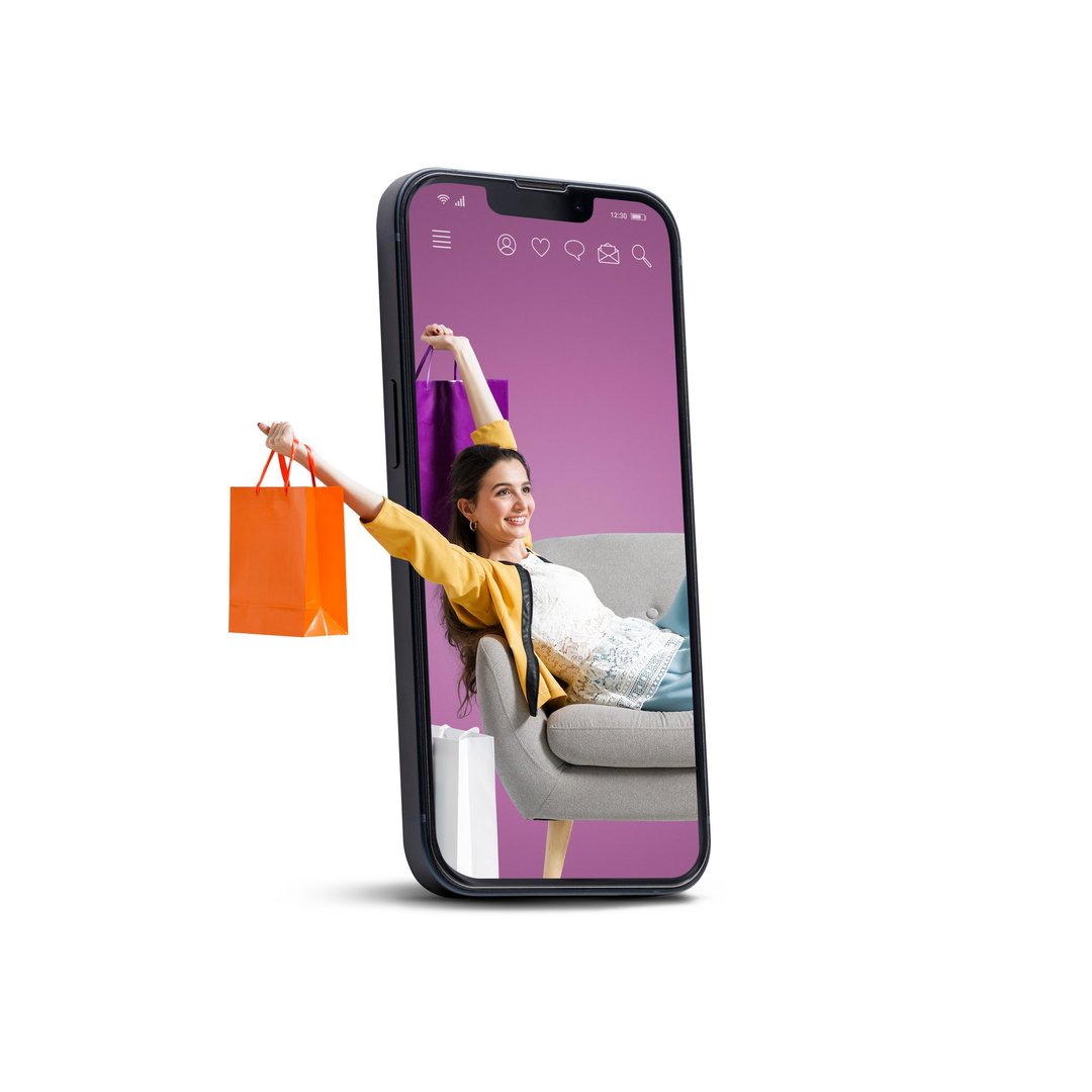 A smartphone displays a woman lounging on a sofa, holding an orange shopping bag, against a purple background.