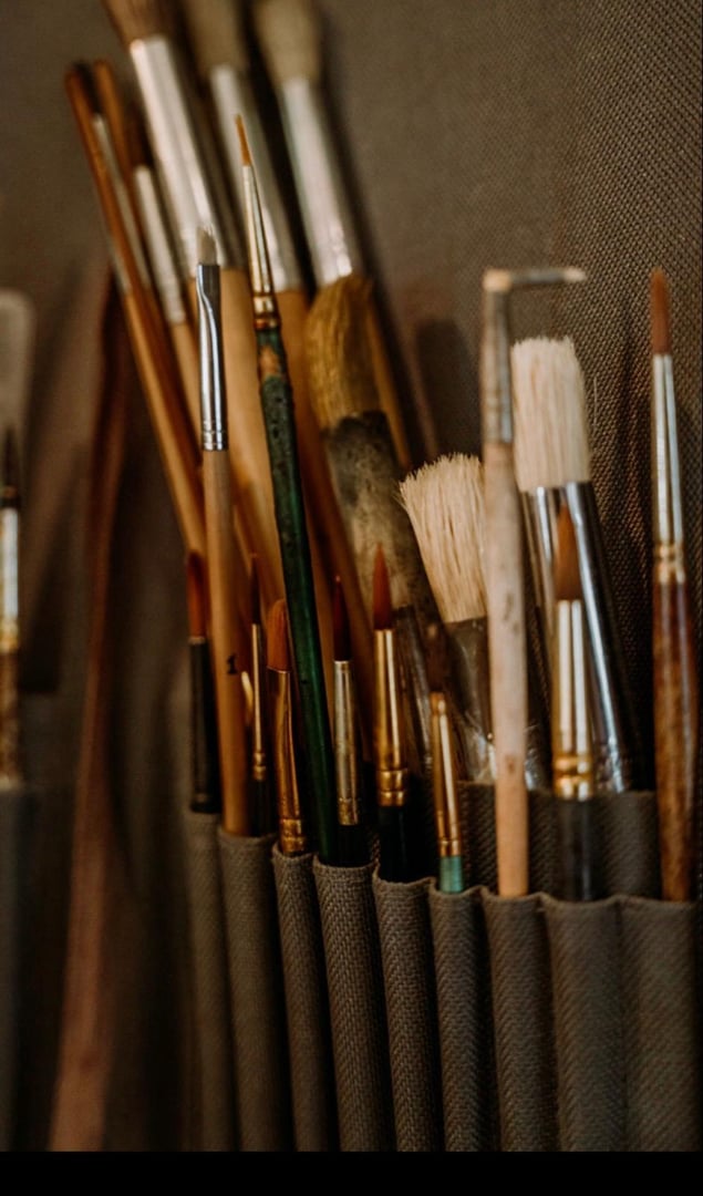 Luthier carefully measuring violin back plate with precision calipers in traditional workshop, demonstrating the meticulous craftsmanship required for creating high quality stringed instruments