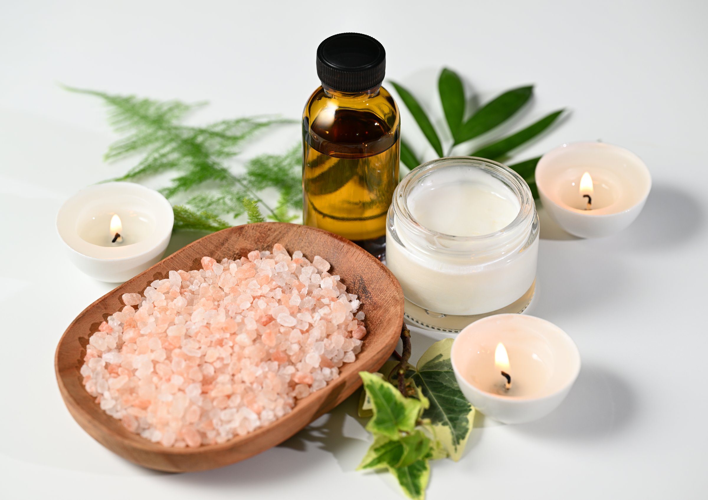 Bodycare products on white table, wellness concept