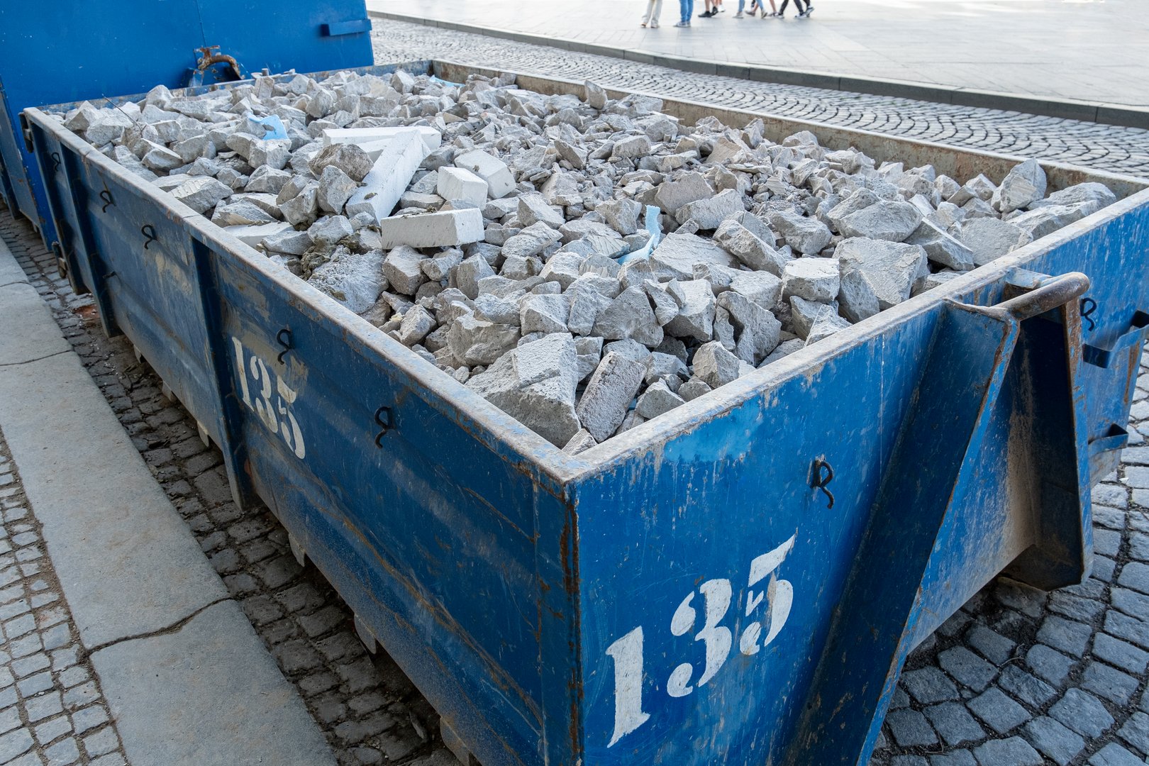 Shattered, broken wall bricks, construction waste after building demolition,in a construction waste container. A collection service is available to handle the disposal of these materials.