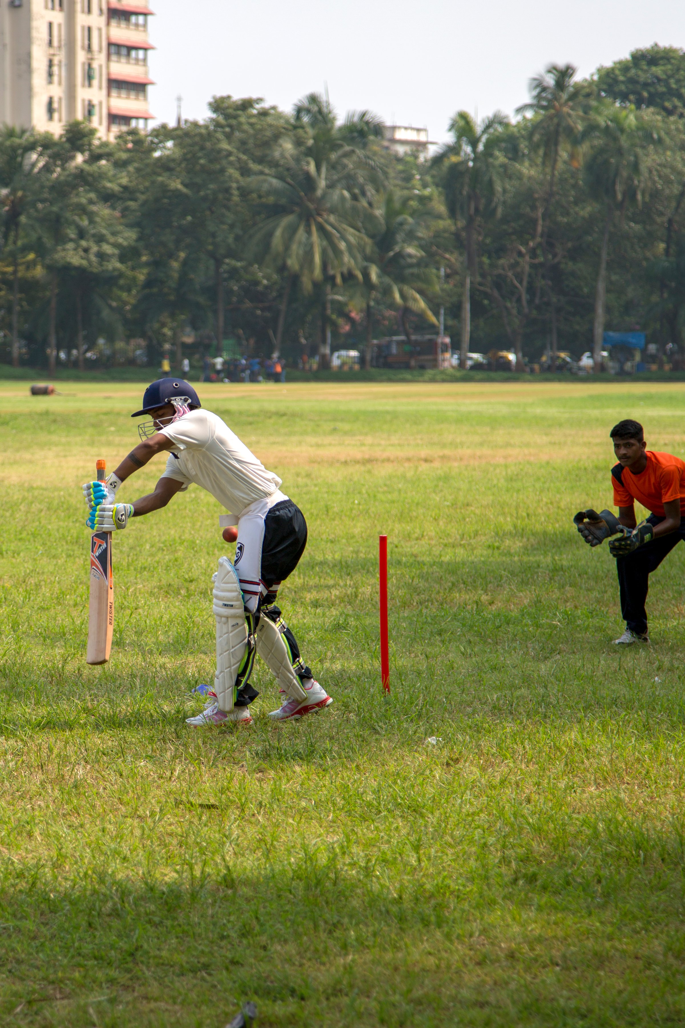Mumbai, India - October 10, 2015: People playing cricket in the central park at Mumbai, India. Cricket is the most popular sport in India. History of cricket in India is based on the existence and development of the British Raj.