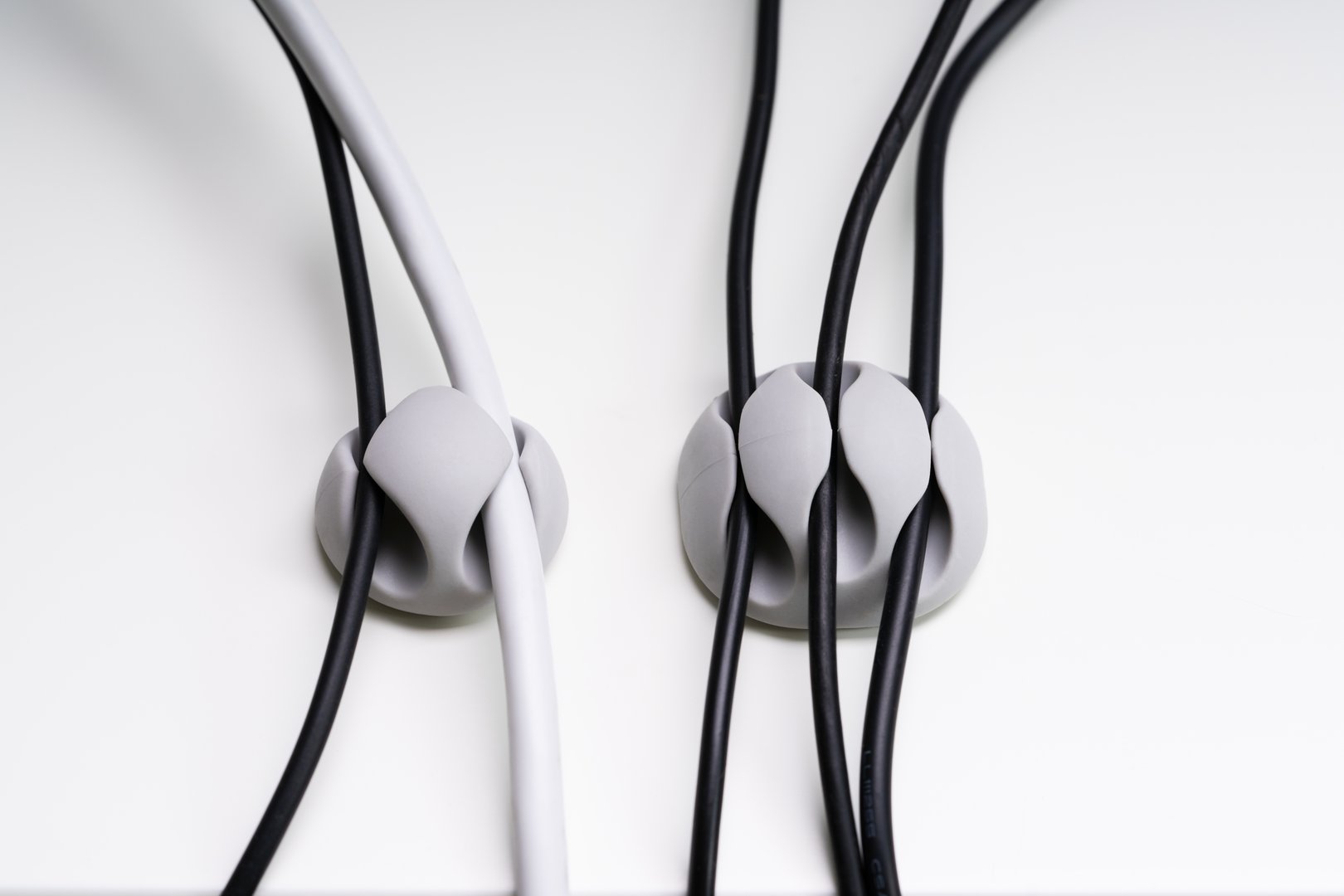 Close-up Of A Sticky Cable Holder On White Surface