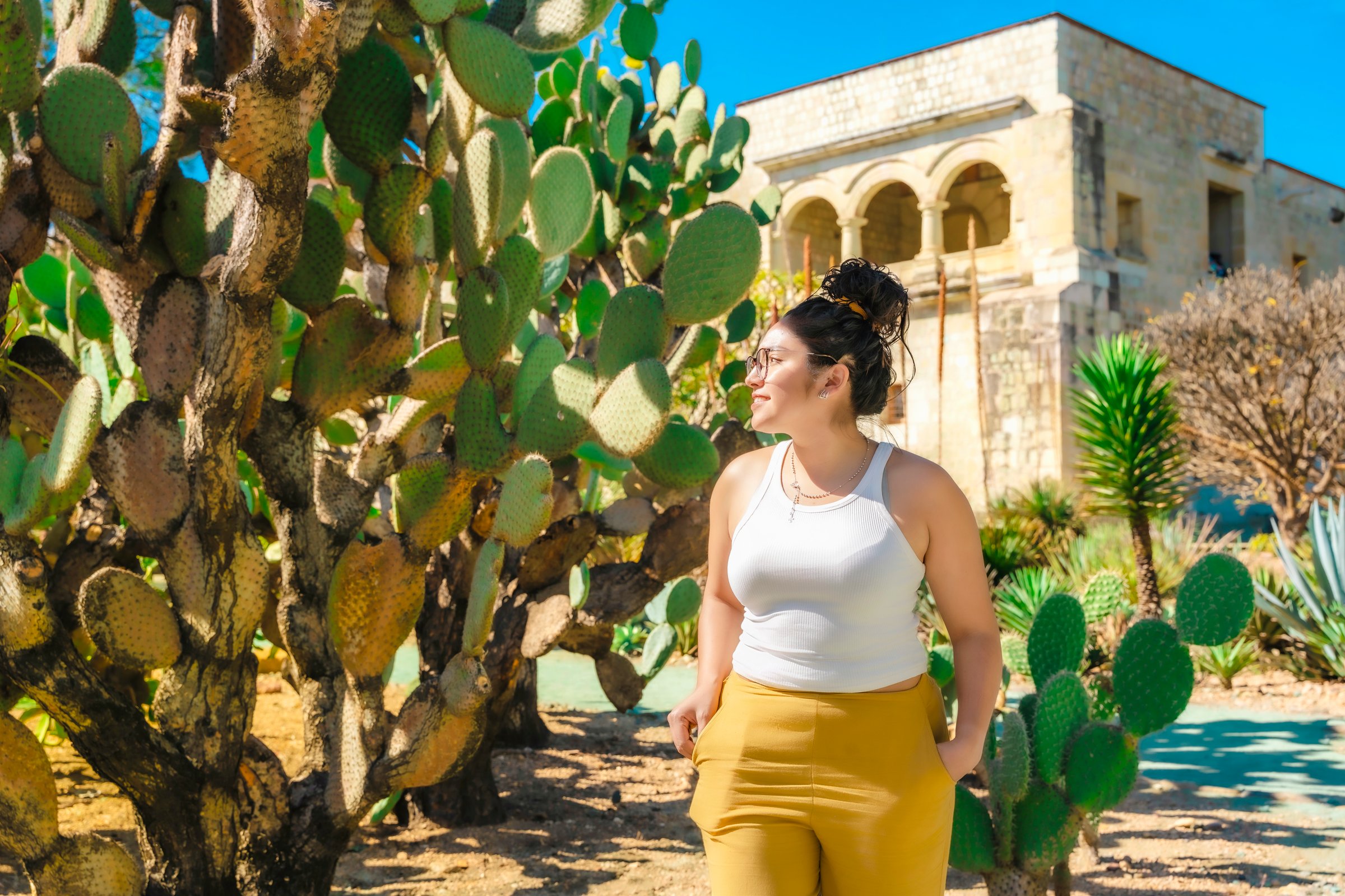 Young Latina woman looking around in the Ethnobotanical Garden next to Santo Domingo in Oaxaca, Mexico.