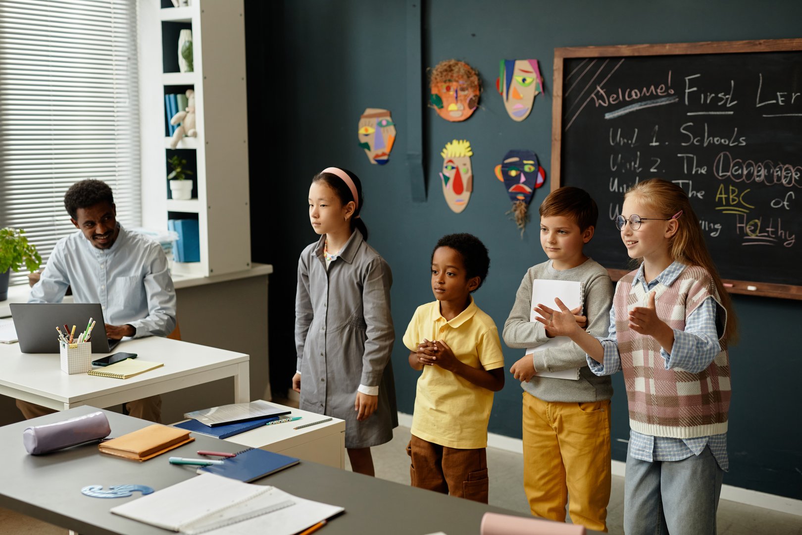 Diverse children presenting their project in classroom with confidence