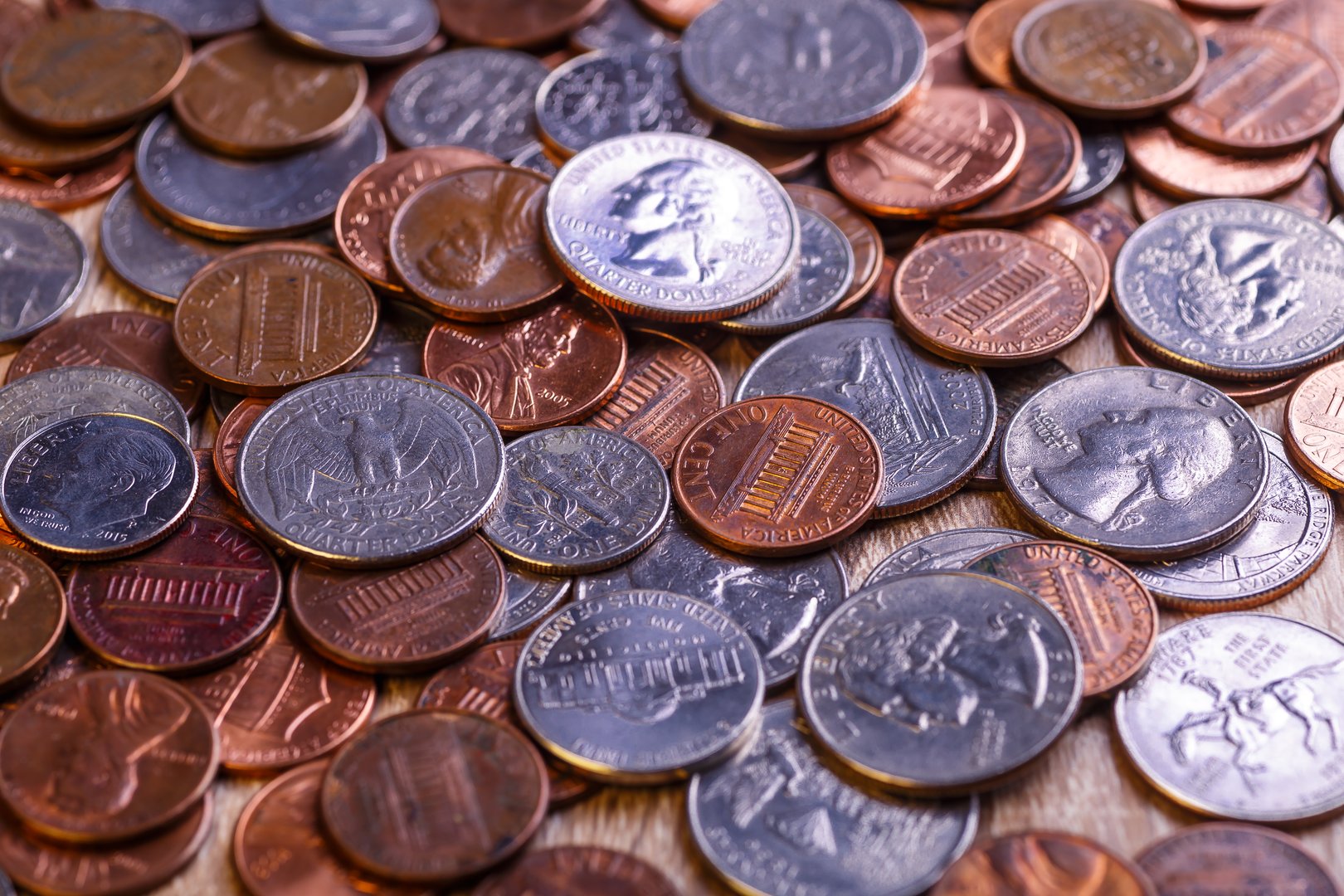 Pile of Golden coin, silver coin, copper coin, quarters, nickels, dimes, pennies, fifty cent piece and dollar coins. Various USA coins, American coins for business, money, financial coins and economy