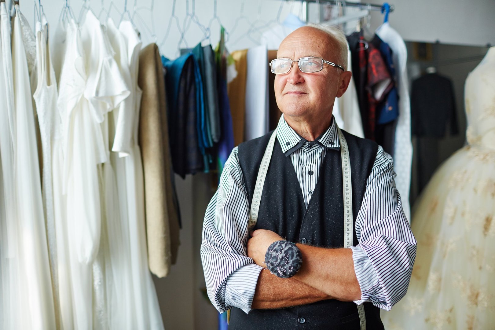 Senior tailor with measuring tape and needle-case