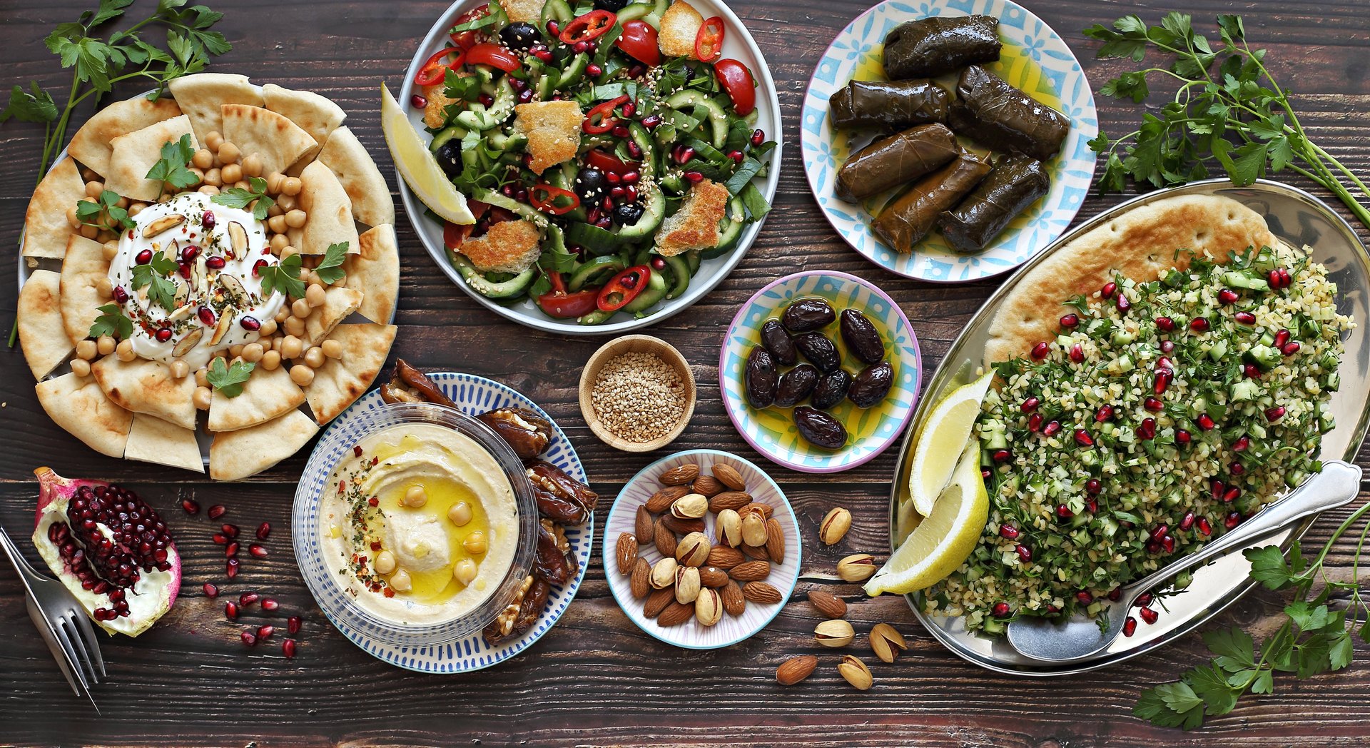 Traditional Lebanese dishes assortment. Chickpea Fatteh, Tabbouleh, Fattoush Salad, Hummus and various of appetizers. Flat layot, selective focus