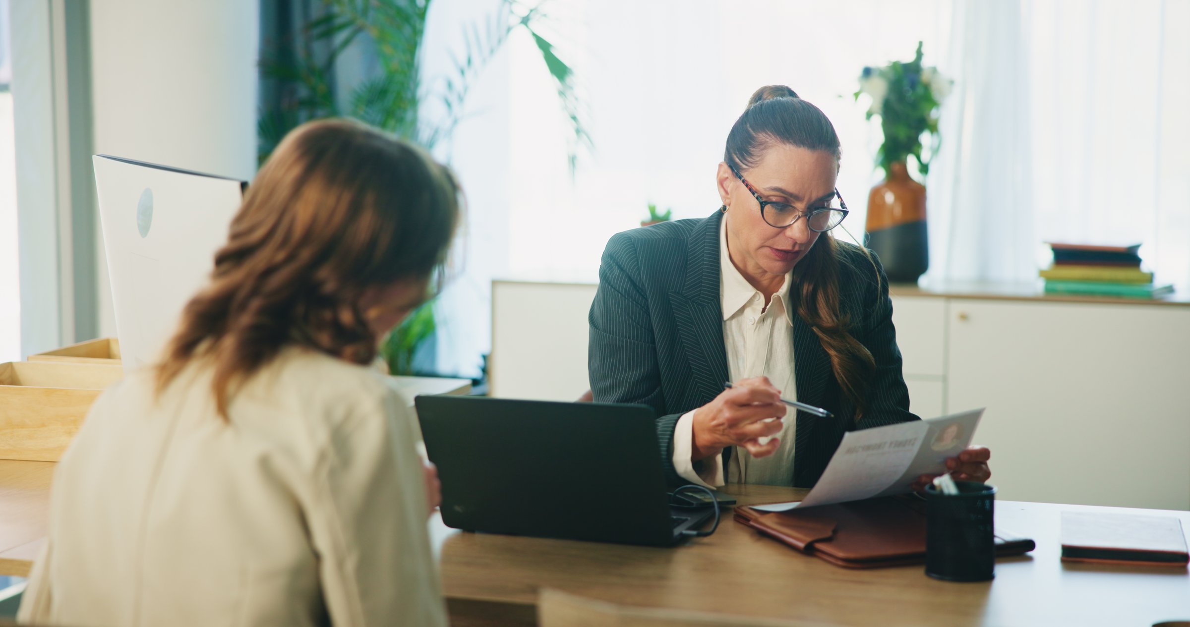 HR, candidate and resume with interview in office for hiring process, job recruitment and internal vacancy. Application, manager and woman with CV document for performance review or company promotion