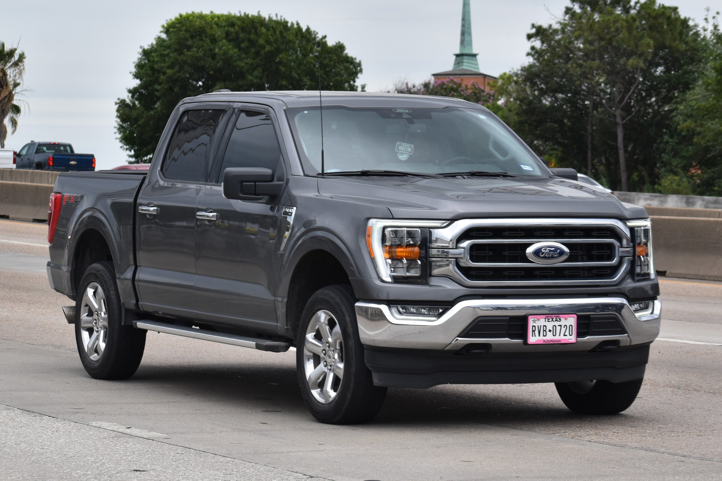 Houston, TX USA - 5/11/2024 - A portrait of a gray Ford F-150 pick-up truck traveling down a highway in moderate traffic