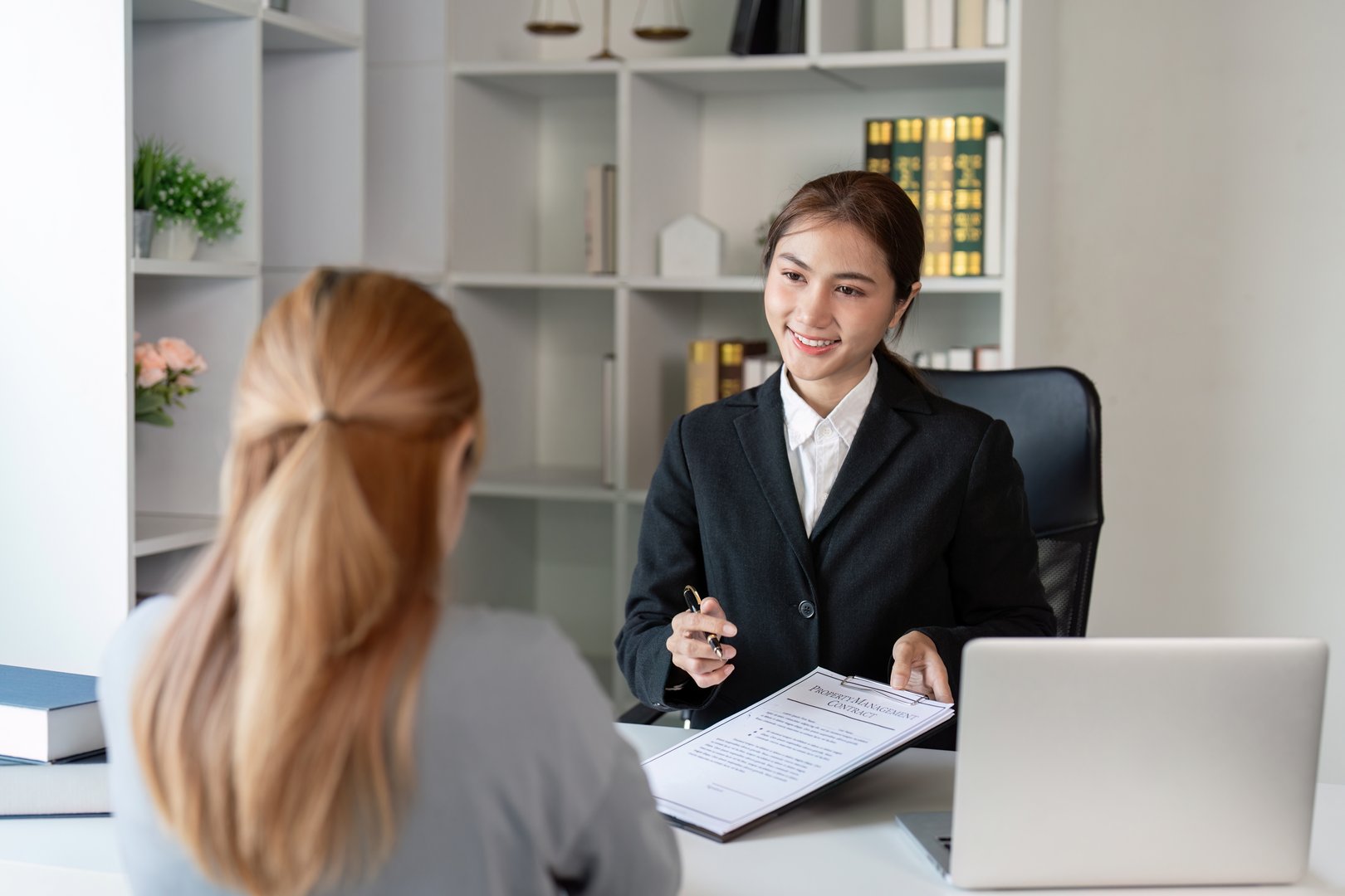 A lawyer offers expert advice to a client in a contemporary office setting ensuring a seamless consultation.