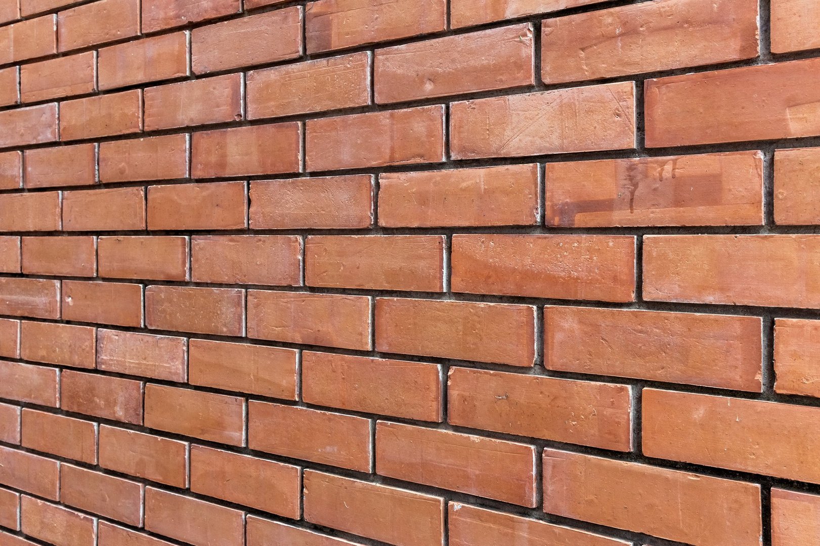 Red brick wall pattern with straight horizontal alignment viewed from a Right perspective